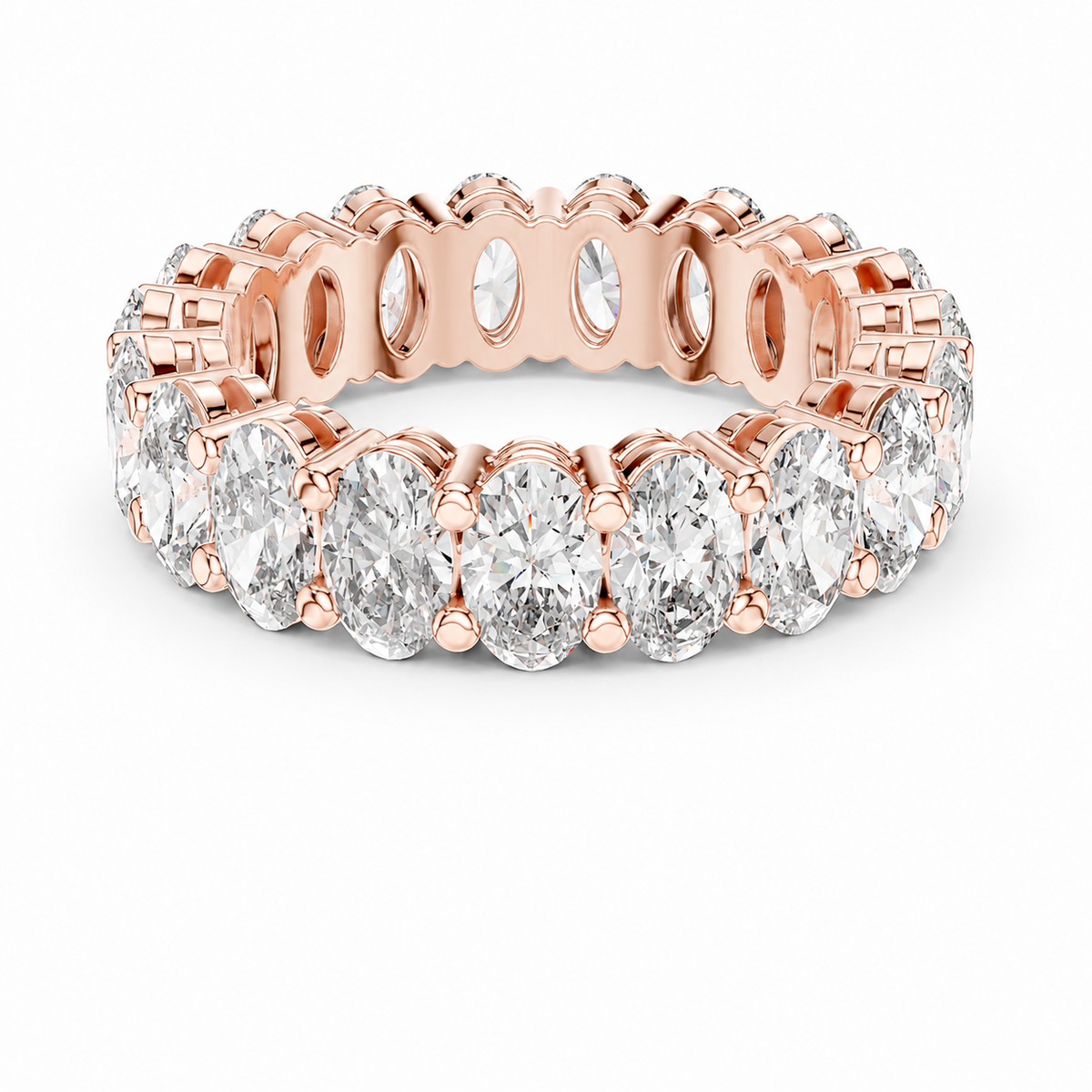 color_10K_RG, color_14K_RG &&	A rose gold eternity ring featuring a continuous row of oval-cut clear gemstones in a prong setting, shown on a clean white background.