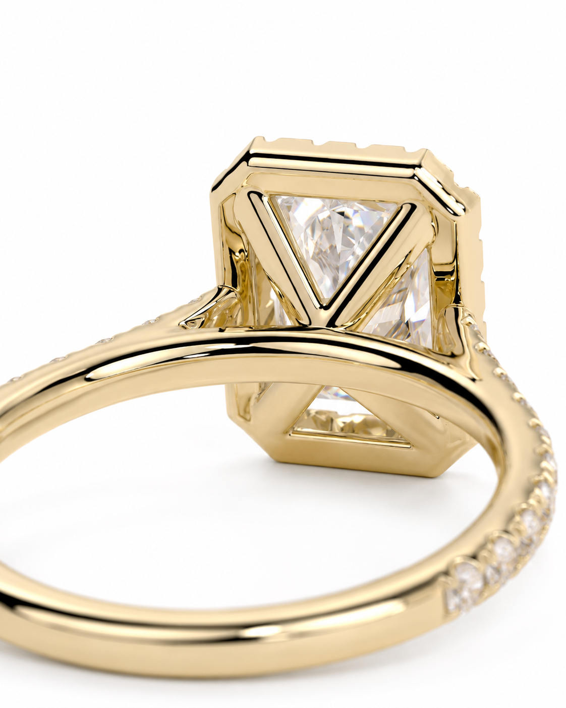 color_10K_YG, color_14K_YG &&A close-up shot of a gold ring featuring a large square-cut clear gemstone in a geometric setting, with smaller pavé-set diamonds along the band, shown against a plain white background.