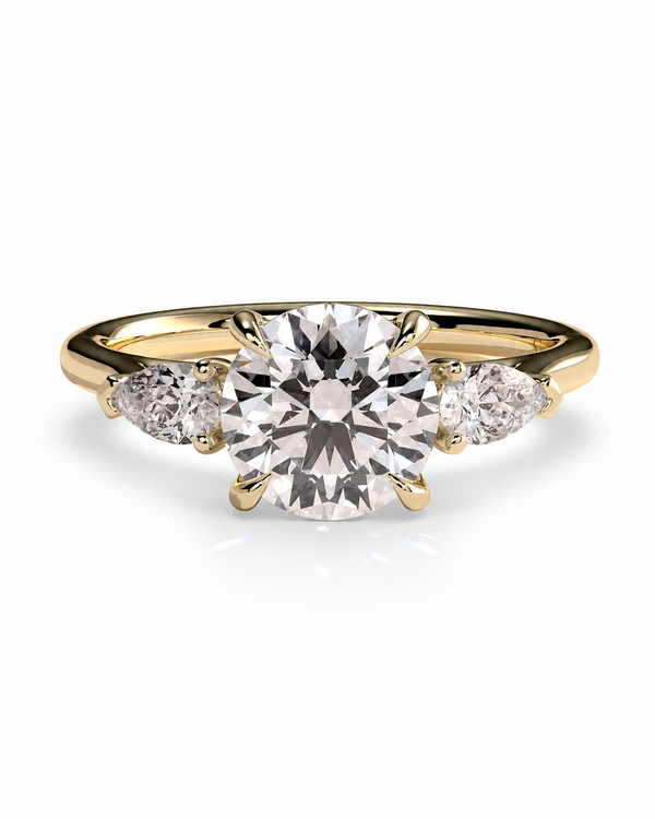 color_10K_YG, color_14K_YG &&A yellow gold solitaire engagement ring featuring a large round brilliant-cut center diamond flanked by two smaller round diamonds on the band, set against a clean white background.