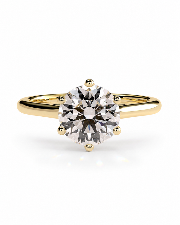 color_10K_YG, color_14K_YG &&A classic solitaire engagement ring featuring a round brilliant-cut diamond set in a yellow gold four-prong band, shown on a clean white background.