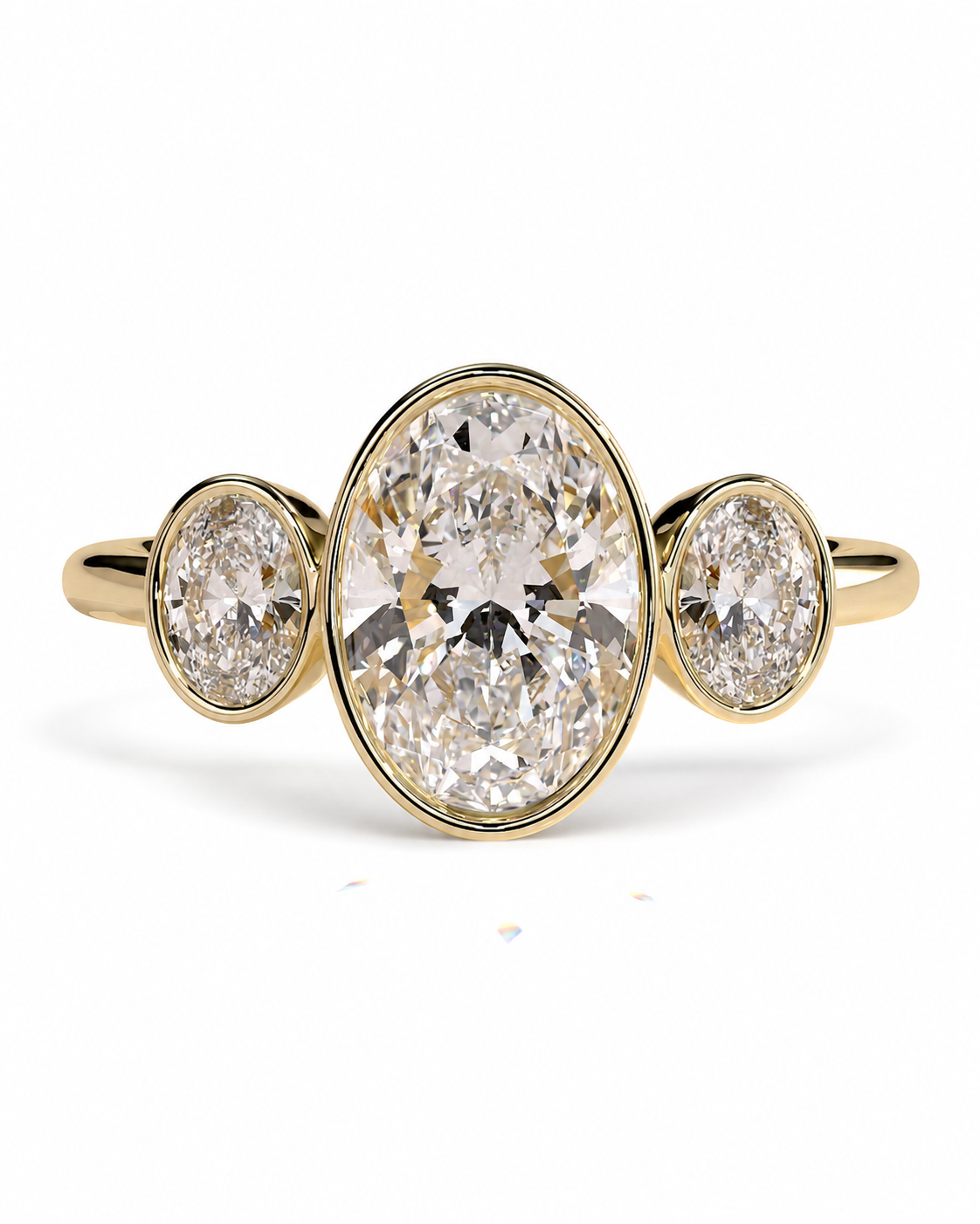 color_10K_YG, color_14K_YG &&A yellow gold three-stone ring featuring a large oval center diamond flanked by two smaller oval side diamonds, set against a clean white background.