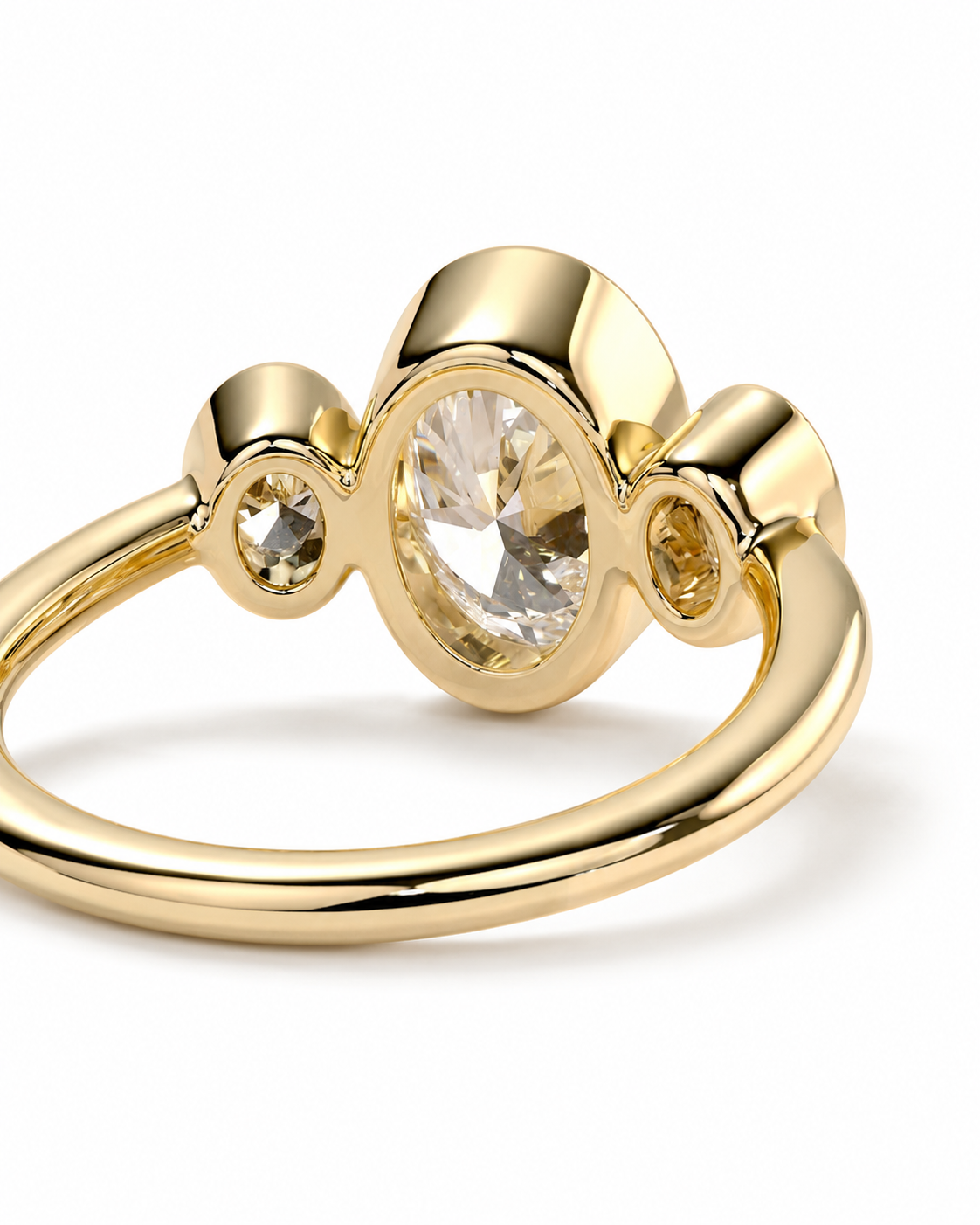 color_10K_YG, color_14K_YG &&A gold ring featuring a large oval clear gemstone in the center, flanked by two smaller round clear gemstones in bezel settings, on a plain white background.