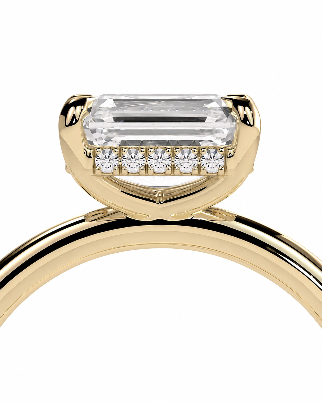 color_10K_YG, color_14K_YG &&A close-up of a yellow gold ring featuring a large rectangular emerald-cut clear center stone and a row of small round-cut stones along the band, set against a plain white background.