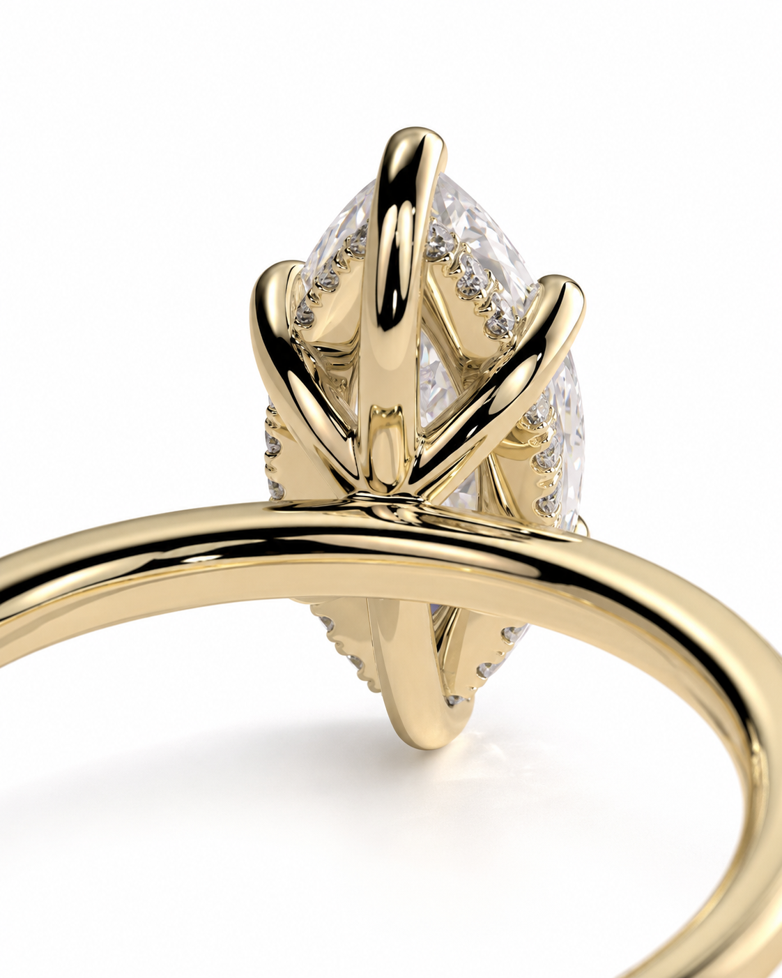color_10K_YG, color_14K_YG &&A close-up of a yellow gold ring featuring a marquise-cut clear gemstone in a prong setting, with small accent stones along the band, shown against a white background.