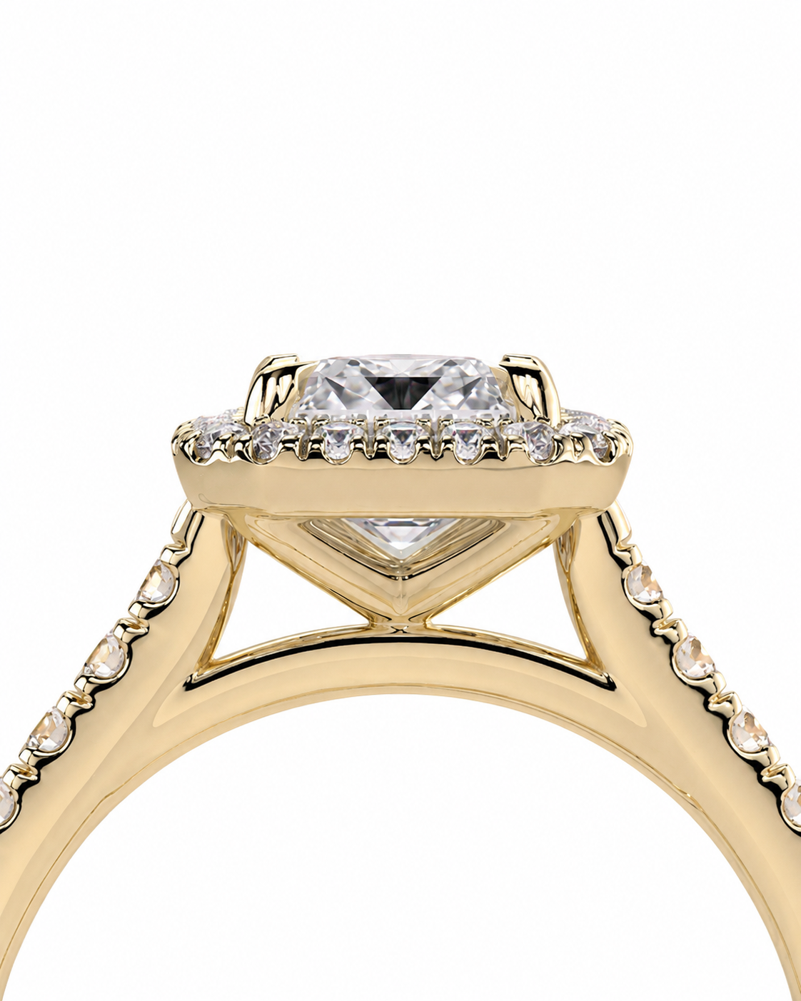 color_10K_YG, color_14K_YG &&A close-up of a yellow gold ring featuring a square-cut clear center stone surrounded by a halo of small clear stones, with additional small stones set along the shoulders, shown on a plain white background.
