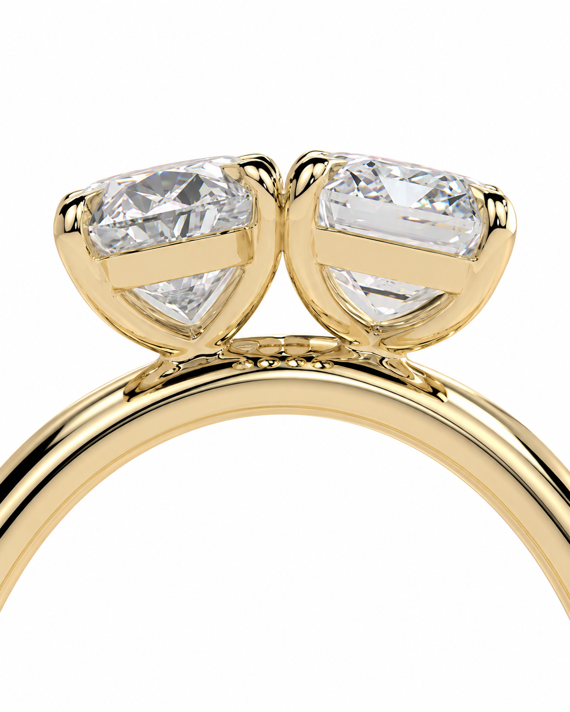 color_10K_YG, color_14K_YG &&A close-up of a yellow gold ring featuring two marquise-cut clear gemstones in a double-prong setting on a polished band, shown against a plain white background.
