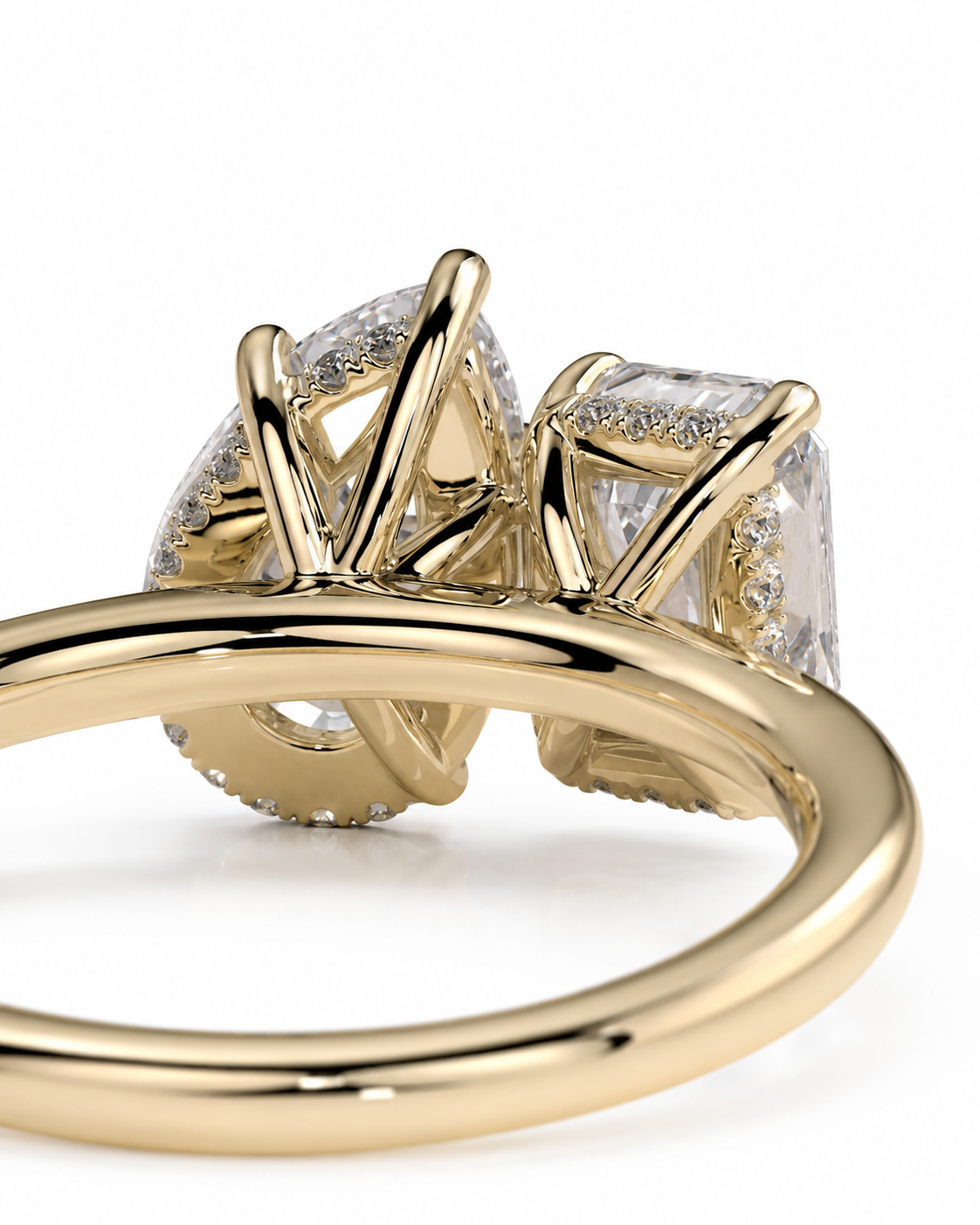 color_10K_YG, color_14K_YG &&A close-up shot of a yellow gold ring featuring a large cushion-cut diamond and a smaller round diamond in a prong setting, with a polished gold band.