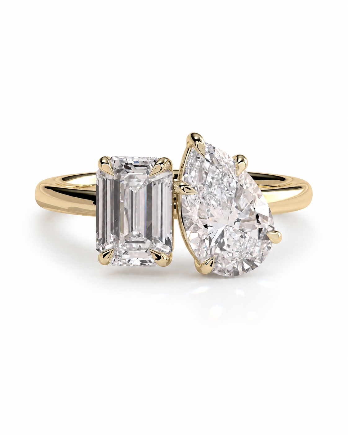 color_10K_YG, color_14K_YG &&A yellow gold ring featuring a rectangular emerald-cut diamond on the left and a pear-cut diamond on the right, set against a clean white background.