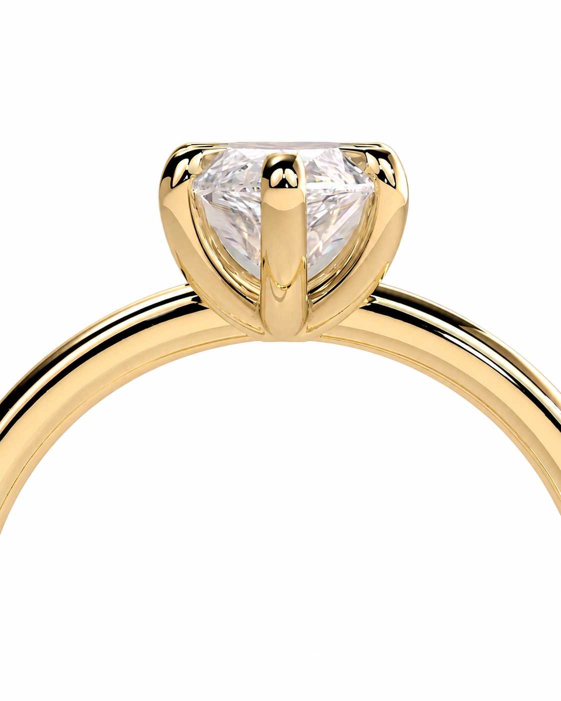 color_10K_YG, color_14K_YG &&A close-up of a yellow gold solitaire engagement ring with a clear round-cut gemstone in a prong setting, shown against a plain white background.