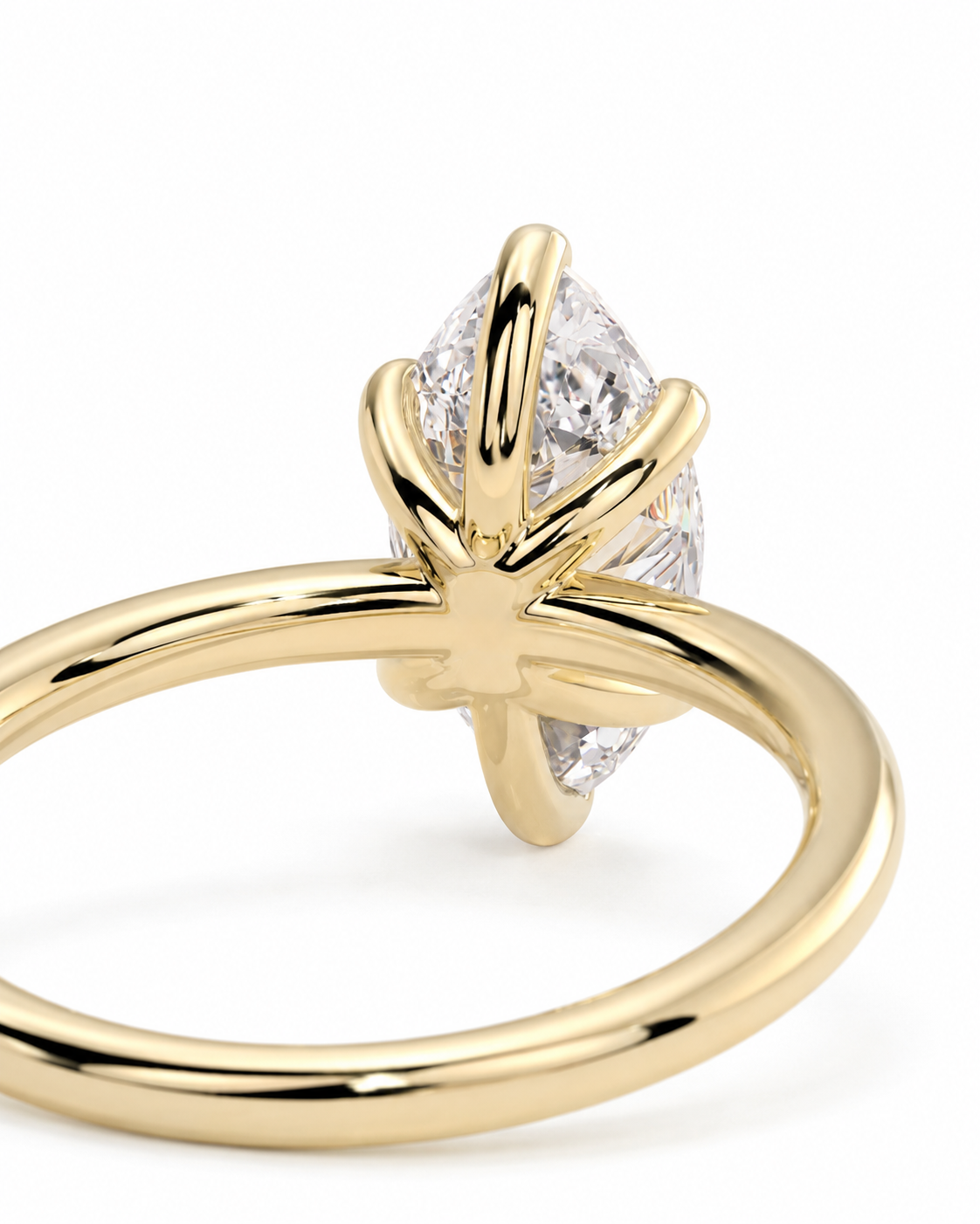 color_10K_YG, color_14K_YG &&A close-up shot of a yellow gold ring featuring a marquise-cut clear gemstone in a prong setting, shown against a clean white background.