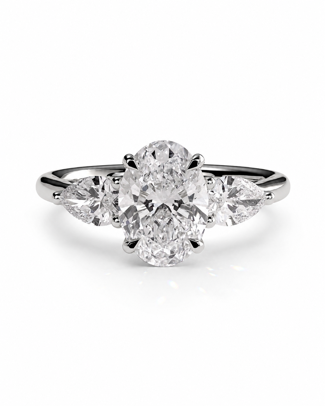 color_925_SIL,color_935_ARG,color_10K_WG, color_14K_WG &&
A three-stone diamond engagement ring with a central oval-cut diamond flanked by two marquise-cut diamonds on a polished silver-colored band, set against a clean white background.