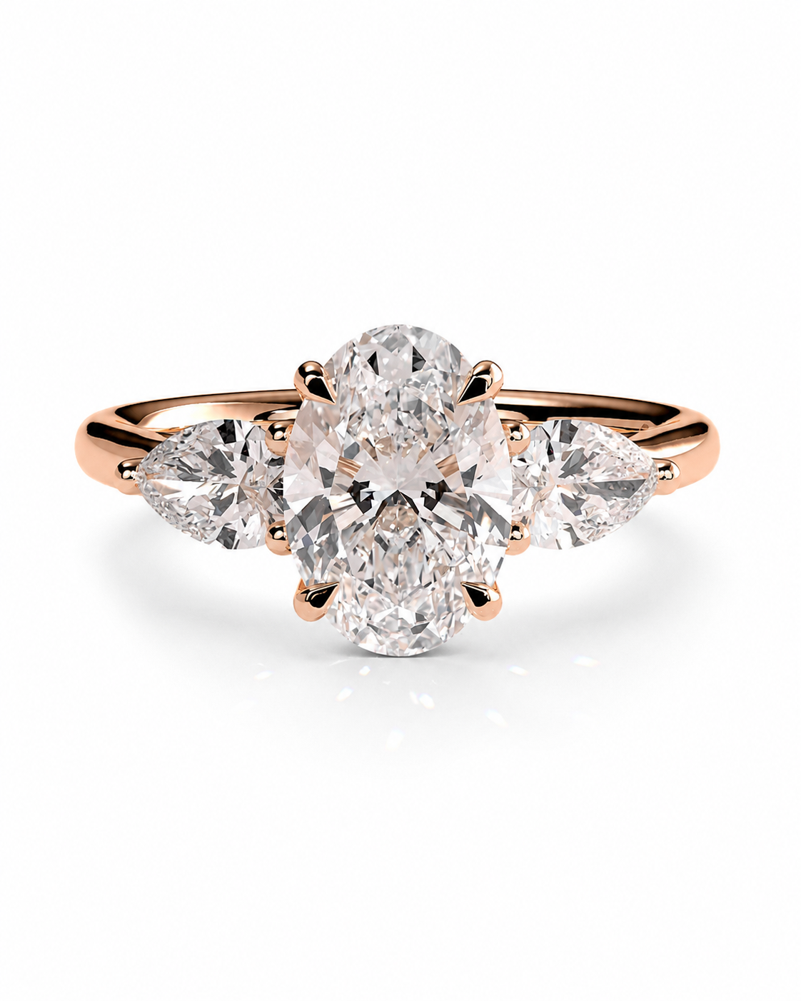 color_10K_RG, color_14K_RG &&
A rose gold three-stone diamond ring featuring a central oval diamond flanked by two marquise-cut diamonds on a clean white background.