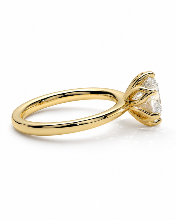 color_10K_YG, color_14K_YG &&A yellow gold solitaire engagement ring with a clear round-cut gemstone in a prong setting, shown on a clean white background.