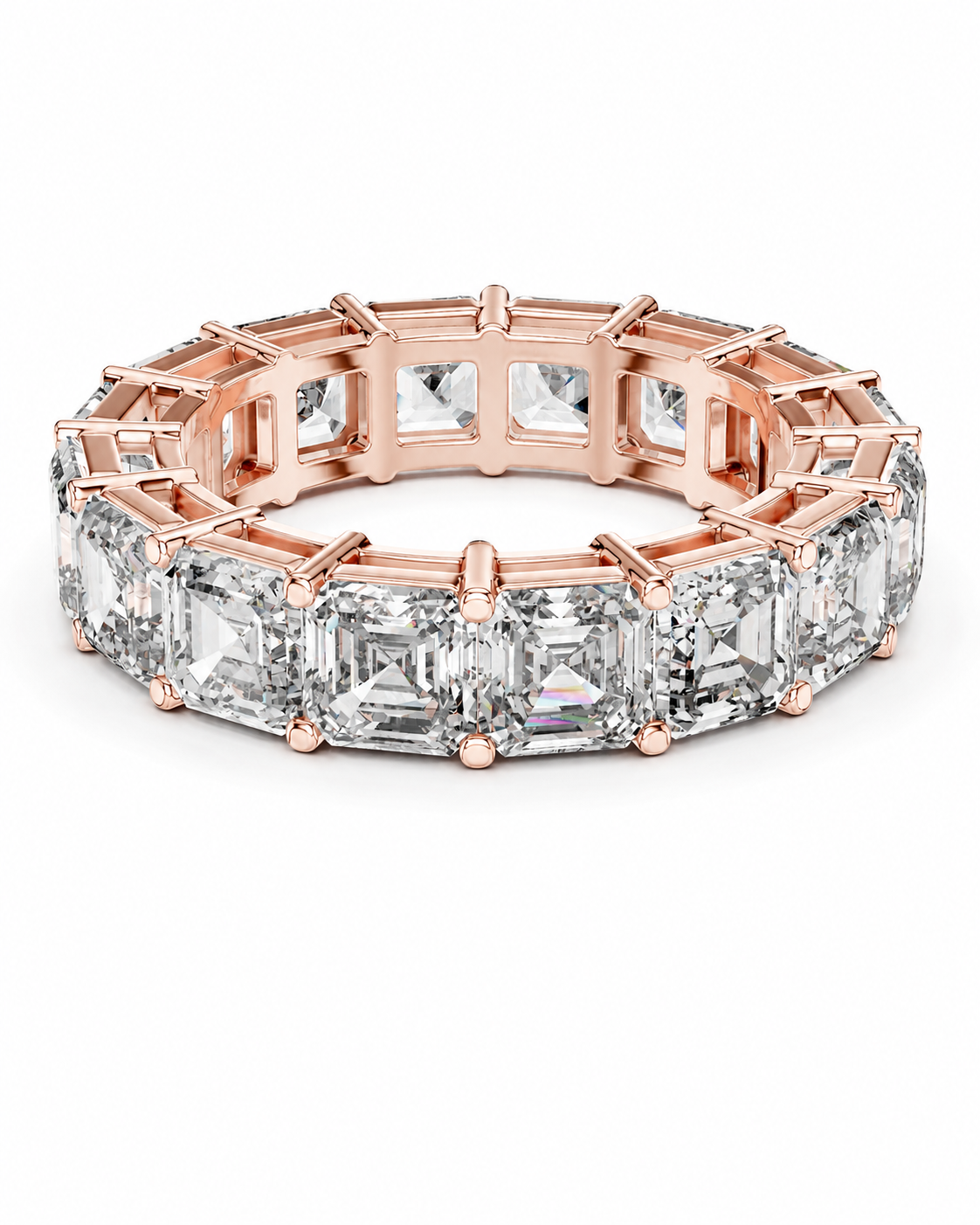 color_10K_RG, color_14K_RG &&	A rose gold eternity ring featuring a continuous row of emerald-cut clear gemstones in a prong setting, shown on a clean white background.