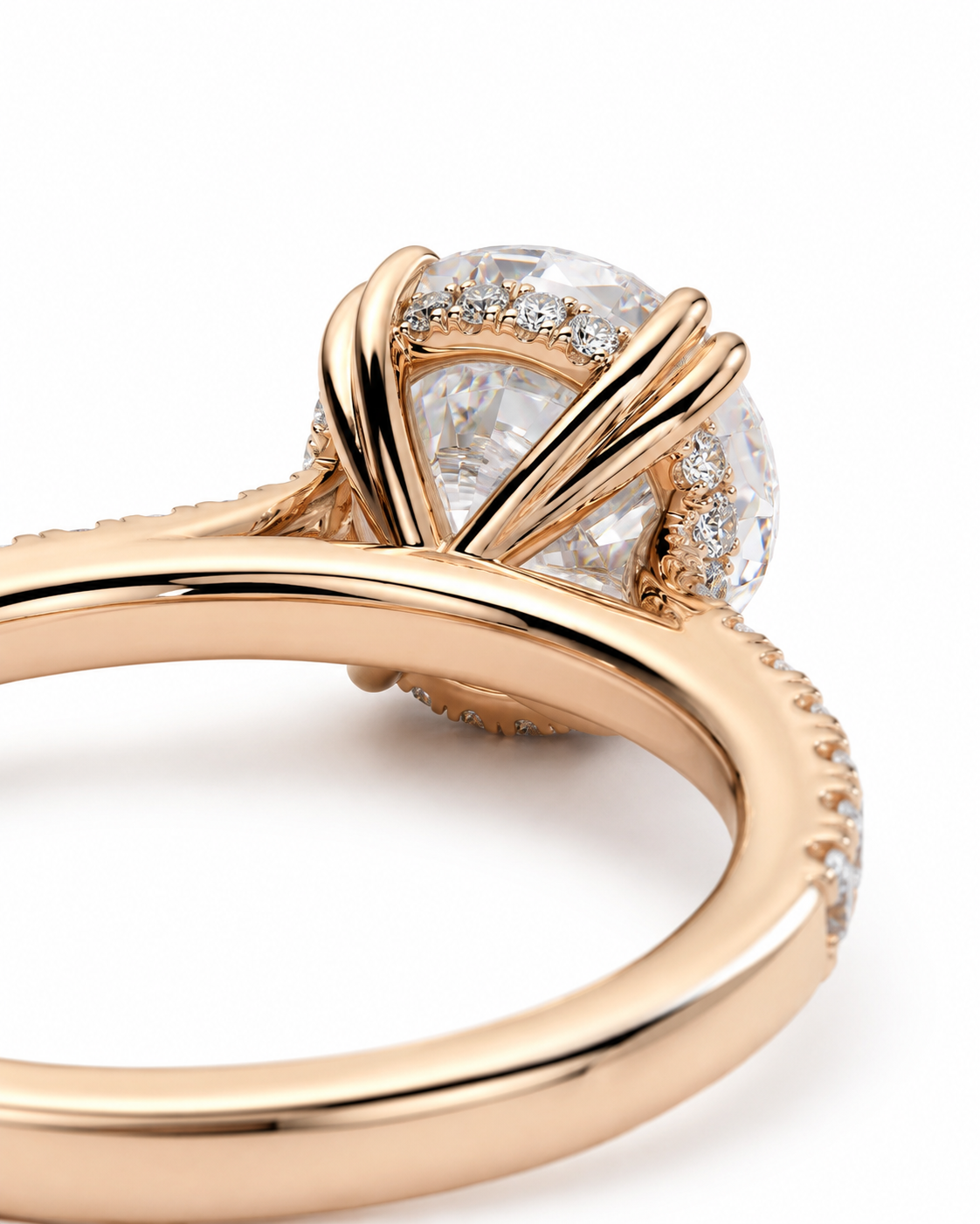 color_10K_RG, color_14K_RG &&
A close-up of a rose gold ring featuring a large oval clear gemstone in a halo setting with a polished band on a white background.