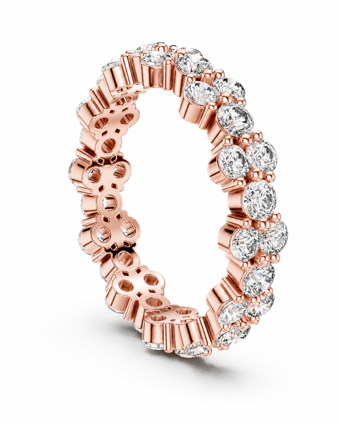color_10K_RG, color_14K_RG &&	A rose gold eternity ring featuring a continuous line of round-cut clear gemstones in a prong setting, shown on a clean white background.