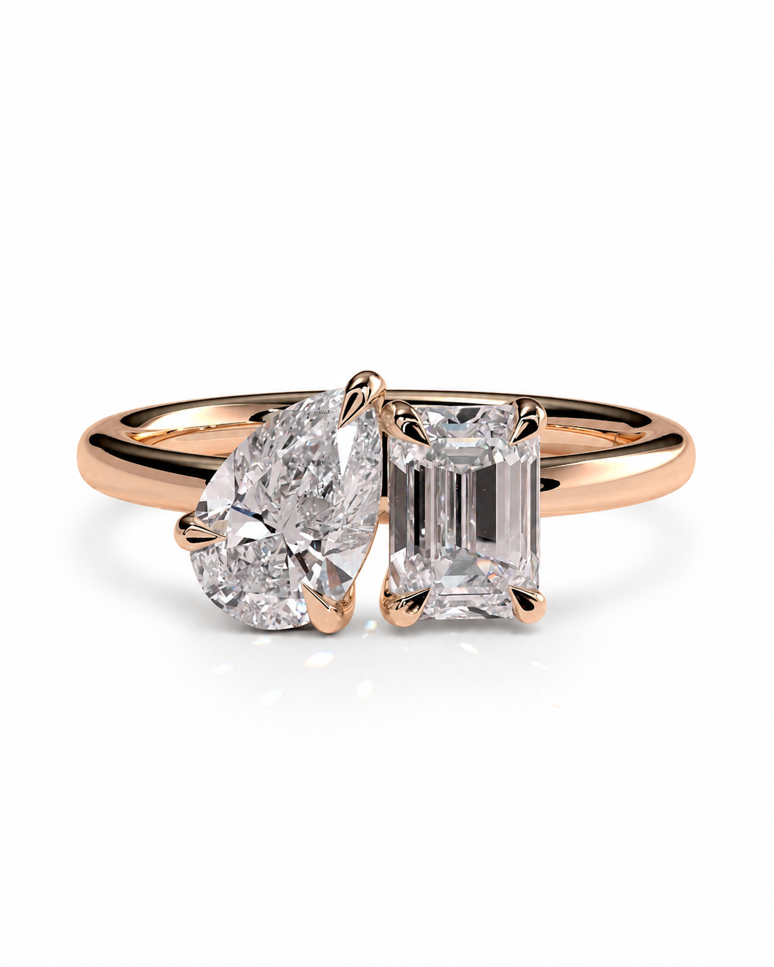 color_10K_RG, color_14K_RG &&
A rose gold engagement ring featuring a heart-shaped diamond and an emerald-cut diamond, set on a polished band against a white background.