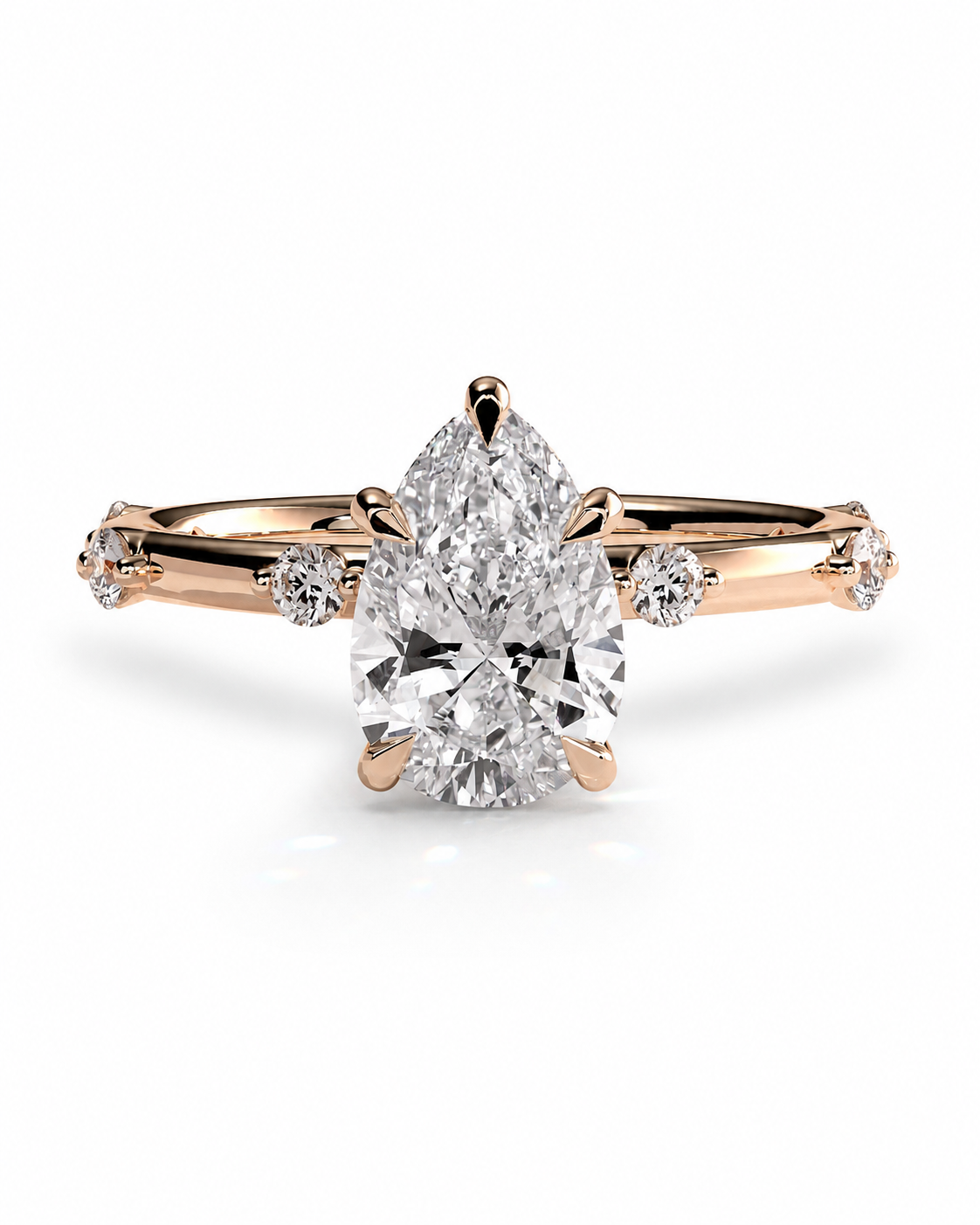 color_10K_RG, color_14K_RG &&
A pear-cut diamond engagement ring in rose gold with small accent diamonds on the band, shown on a clean white background.