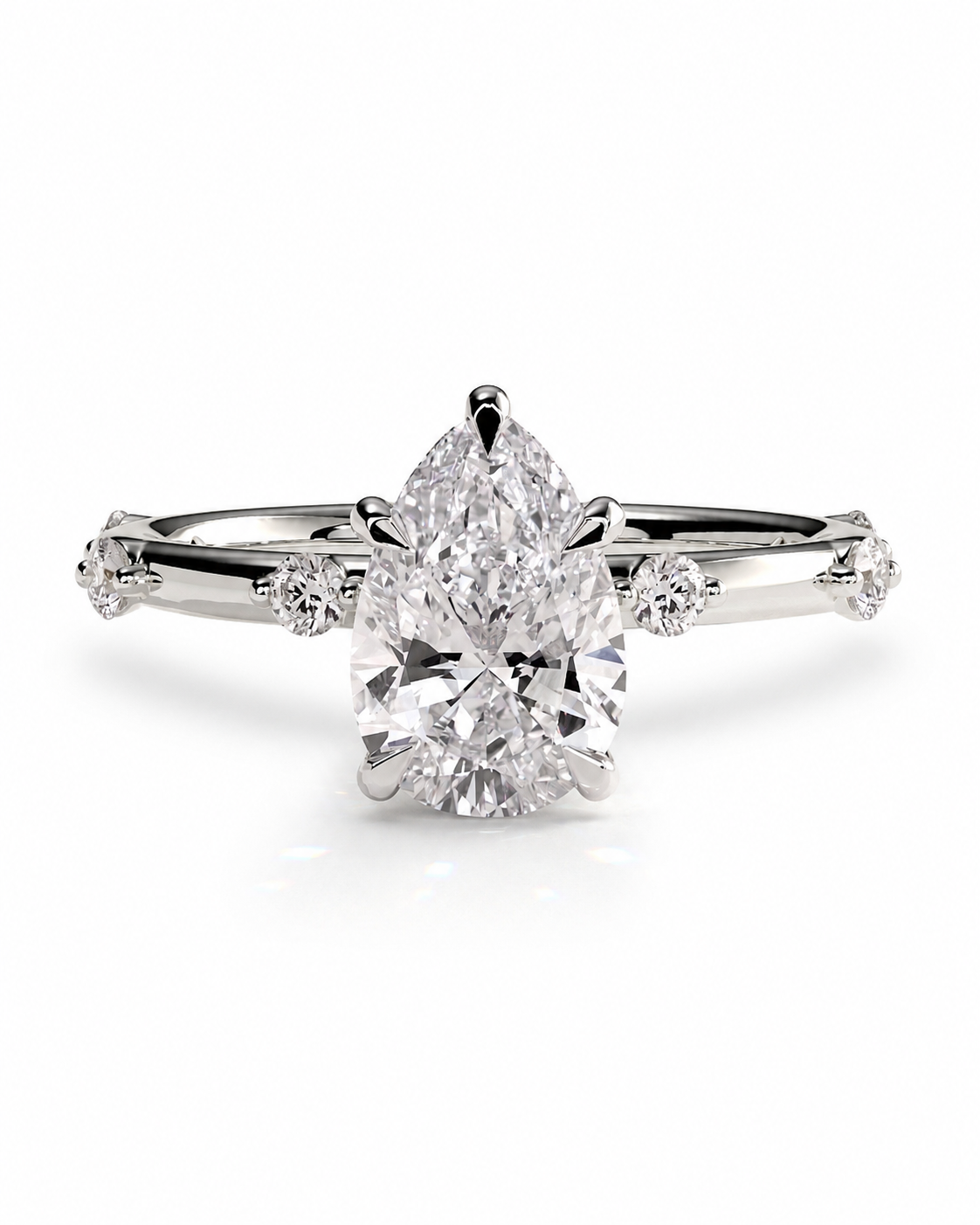 color_925_SIL,color_935_ARG,color_10K_WG, color_14K_WG &&
A pear-cut diamond engagement ring with a brilliant-cut center stone and smaller diamonds along the shoulders of a polished white gold or platinum band, set against a clean white background.