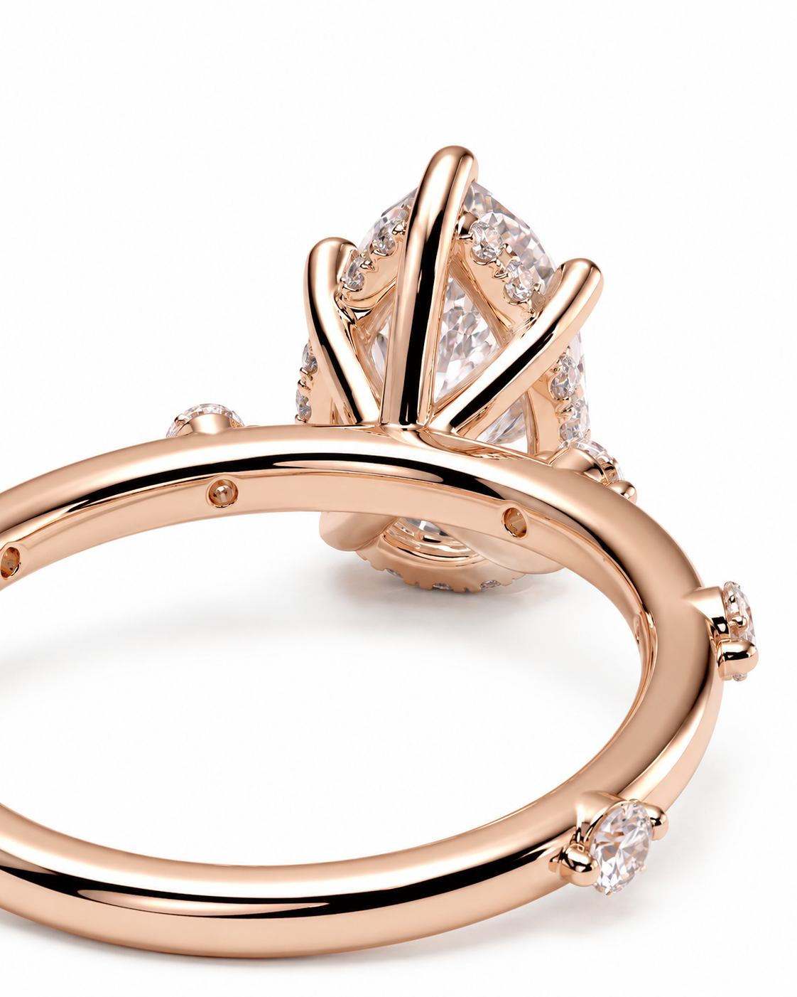color_10K_RG, color_14K_RG &&
A close-up of a rose gold ring with a large clear marquise-cut center stone and smaller accent stones along the band, set against a plain white background.