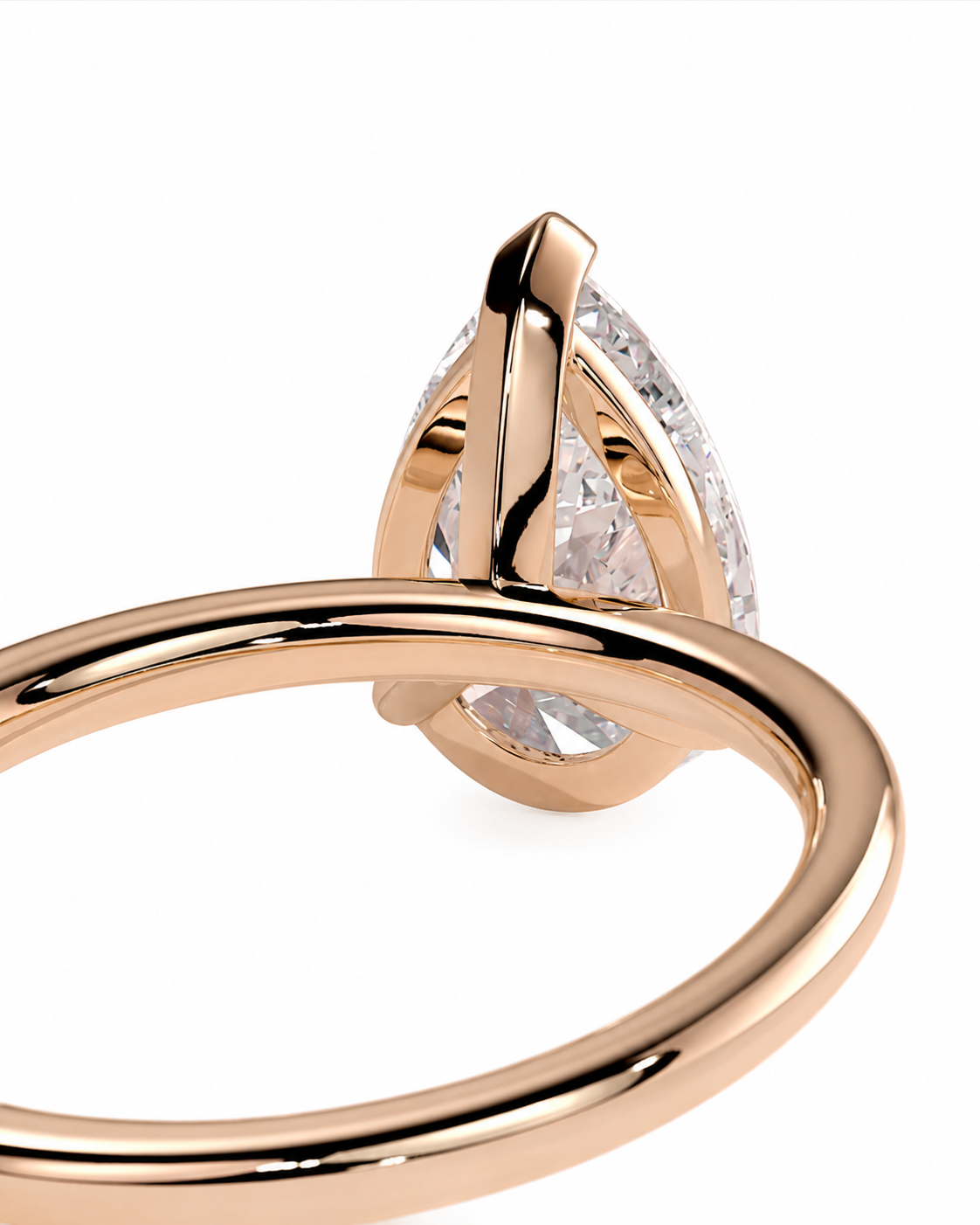 color_10K_RG, color_14K_RG &&
A close-up shot of a rose gold ring featuring a marquise-cut clear gemstone in a unique prong setting, shown against a plain white background.