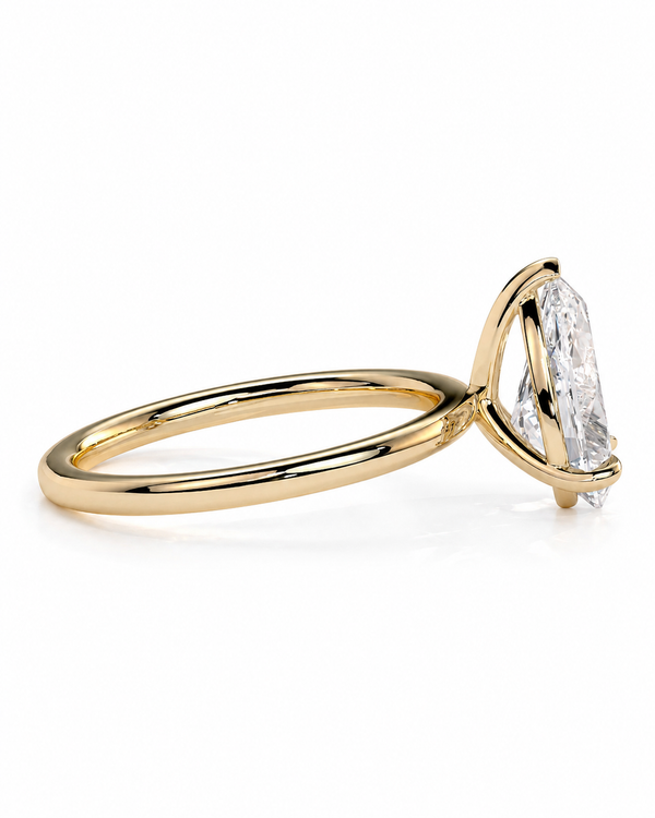 color_10K_YG, color_14K_YG &&
A yellow gold solitaire ring featuring a large, bezel-set marquise-cut clear gemstone, shown from a side profile view on a clean white background.