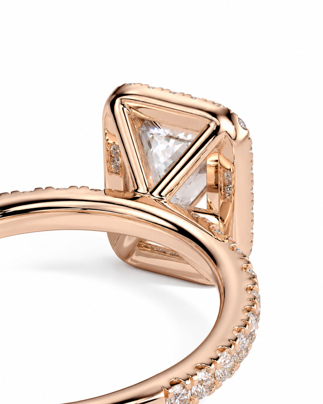 color_10K_RG, color_14K_RG &&Close-up of a rose gold ring featuring a large triangular clear gemstone in a geometric setting, with pave-set clear stones along the band, on a white background.