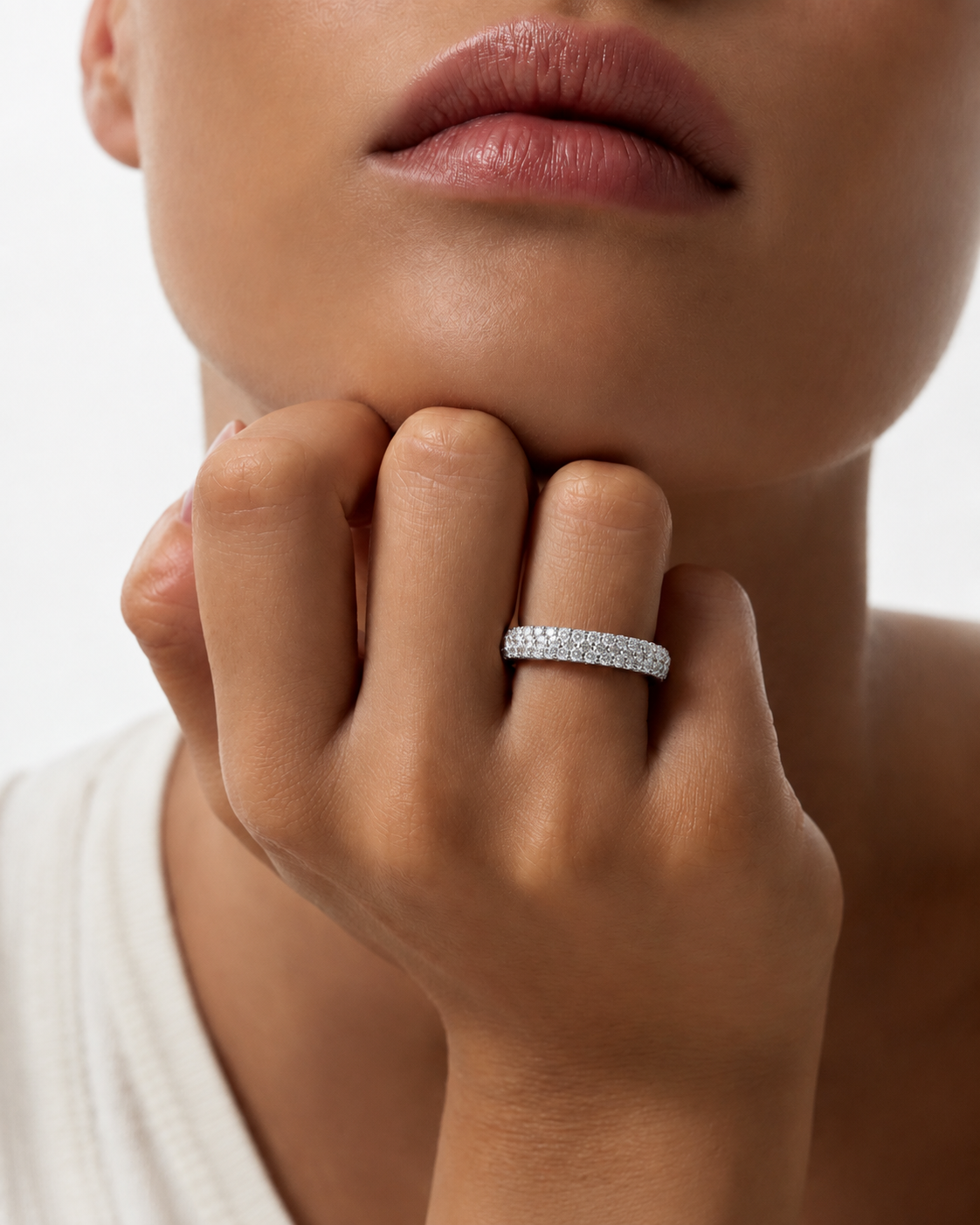 color_925_SIL,color_935_ARG,color_10K_WG, color_14K_WG &&	
A close-up lifestyle shot of a model wearing a thin, pave-set silver band ring on her finger, with her hand resting near her chin against a clean white background.
