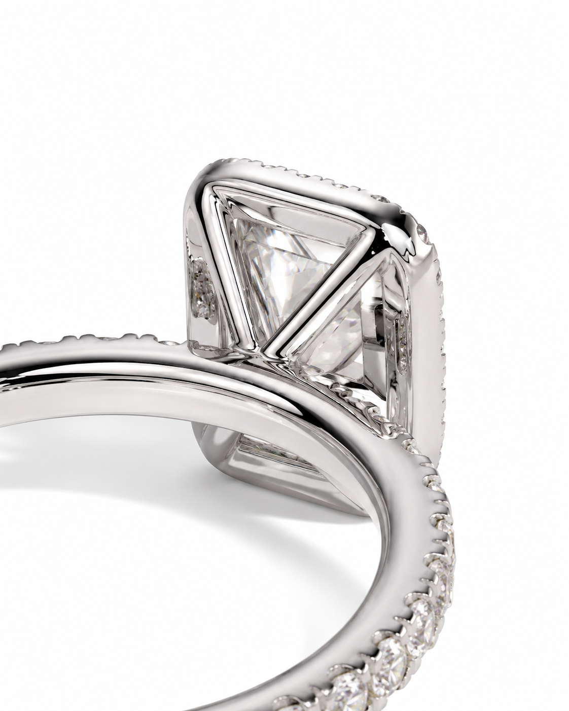 color_925_SIL,color_935_ARG,color_10K_WG, color_14K_WG &&A close-up of a silver-toned ring featuring a large clear triangular gemstone in a square bezel setting, with a pave band on a white background.