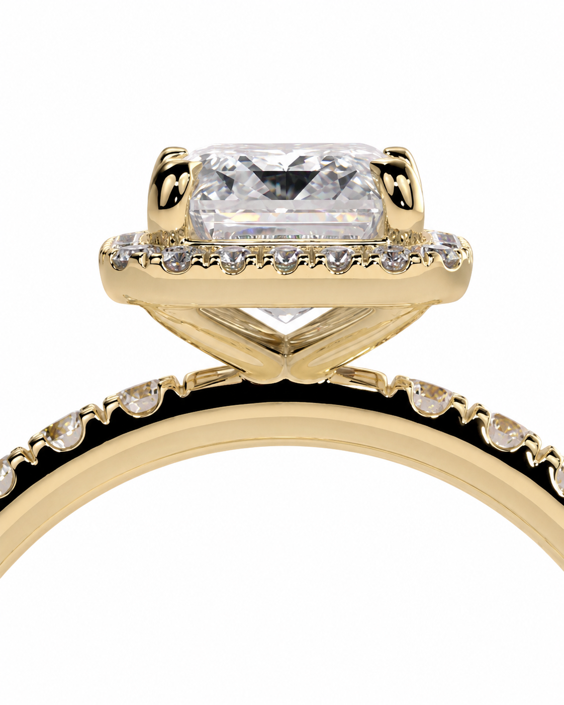 color_10K_YG, color_14K_YG &&A close-up of a yellow gold ring featuring a large rectangular clear gemstone in a prong setting, with small accent stones along the band and a halo around the main stone, shown on a white background.