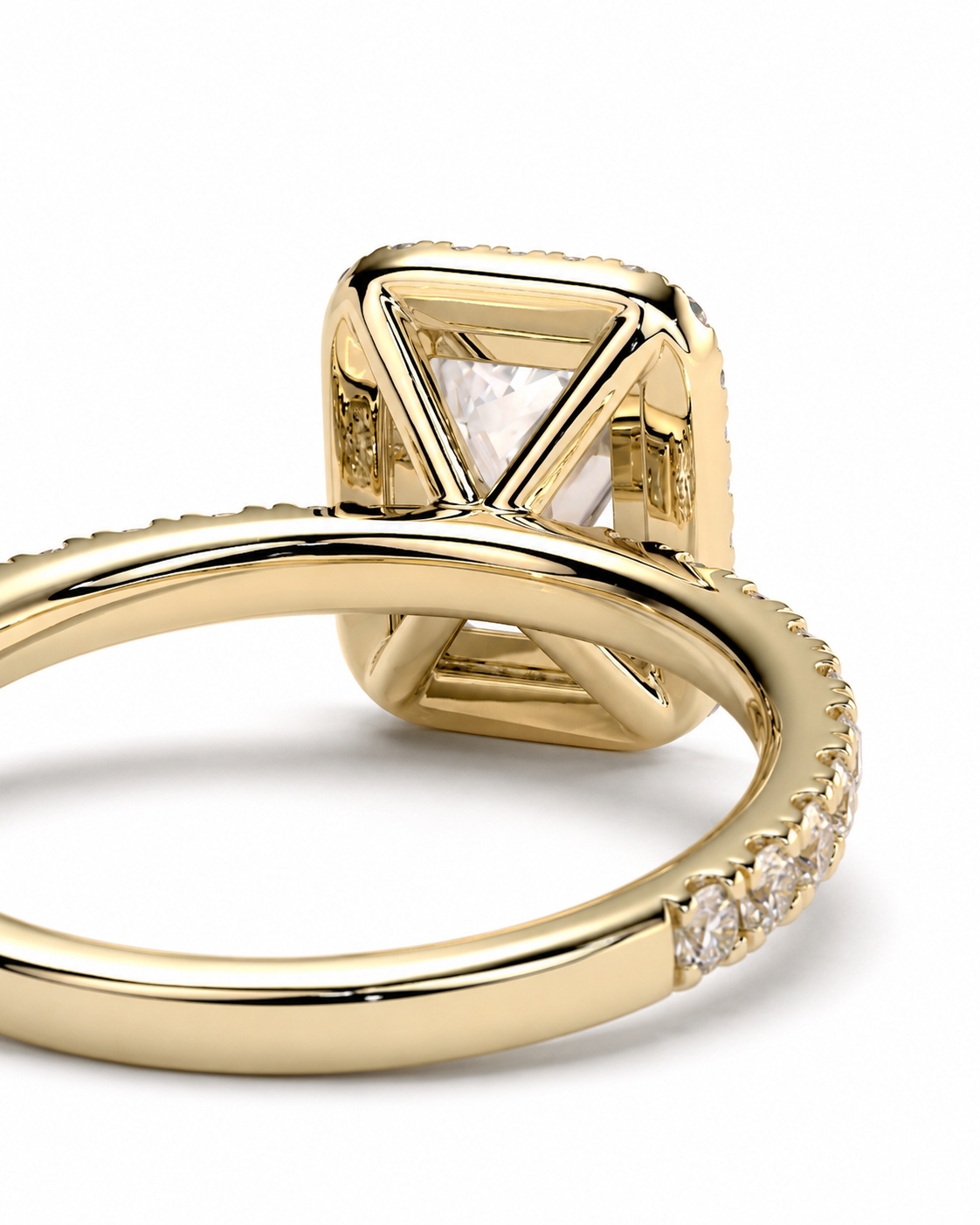 color_10K_YG, color_14K_YG &&A close-up of a yellow gold ring featuring a square cushion-cut diamond with a triangular bezel setting and a row of small pave diamonds along the band, shown on a white background.