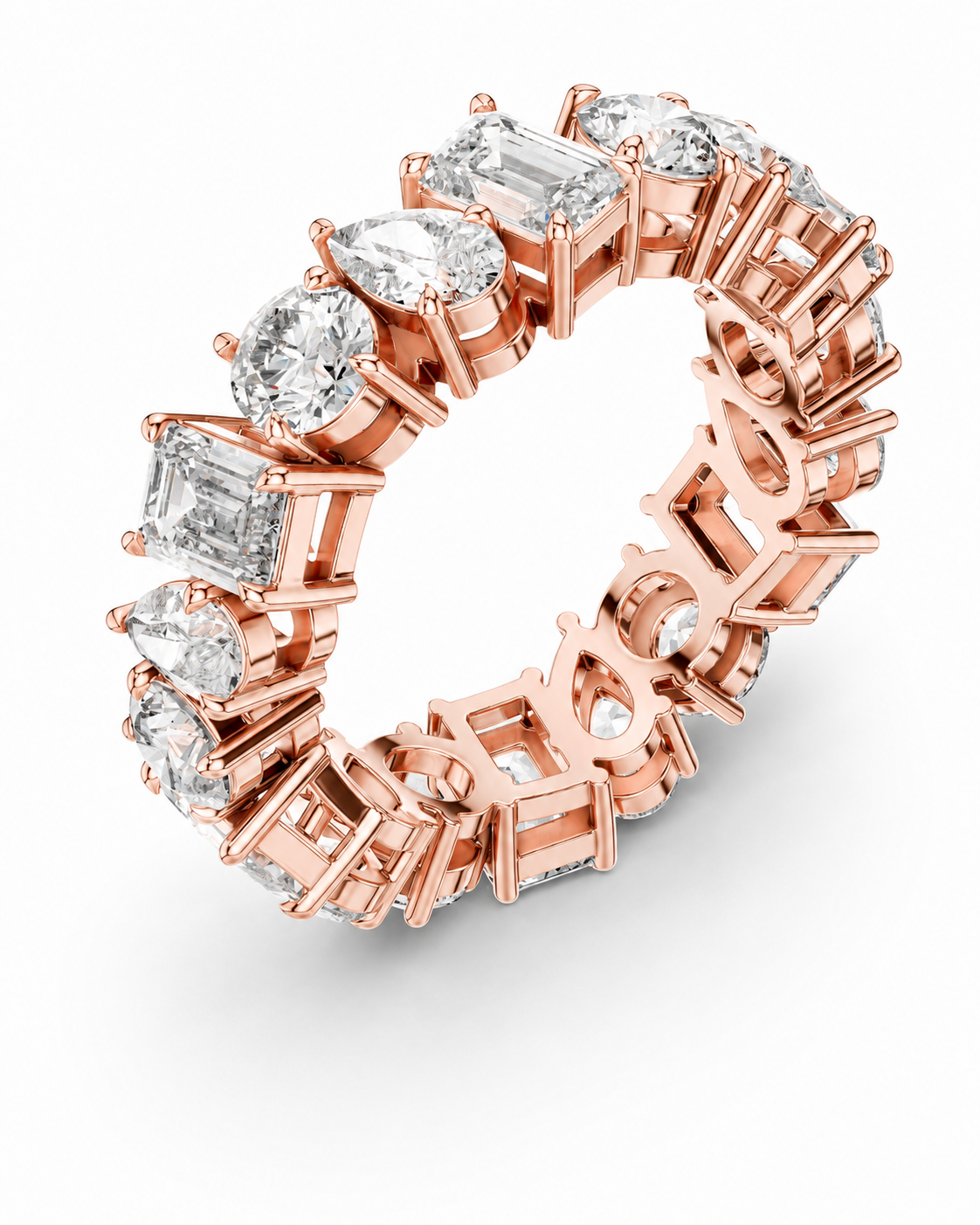 color_10K_RG, color_14K_RG &&	A rose gold eternity ring featuring a continuous row of clear gemstones in oval, round, and baguette cuts, set against a clean white background.