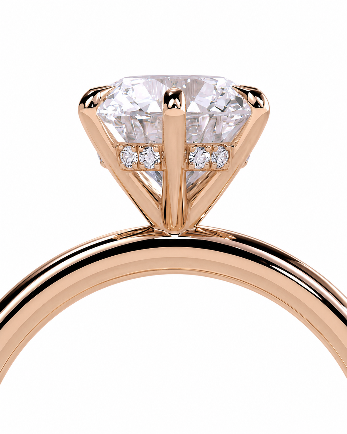 color_10K_RG, color_14K_RG &&A close-up of a rose gold ring featuring a large round-cut clear center stone in a prong setting, with small accent stones along the band, shown on a white background.