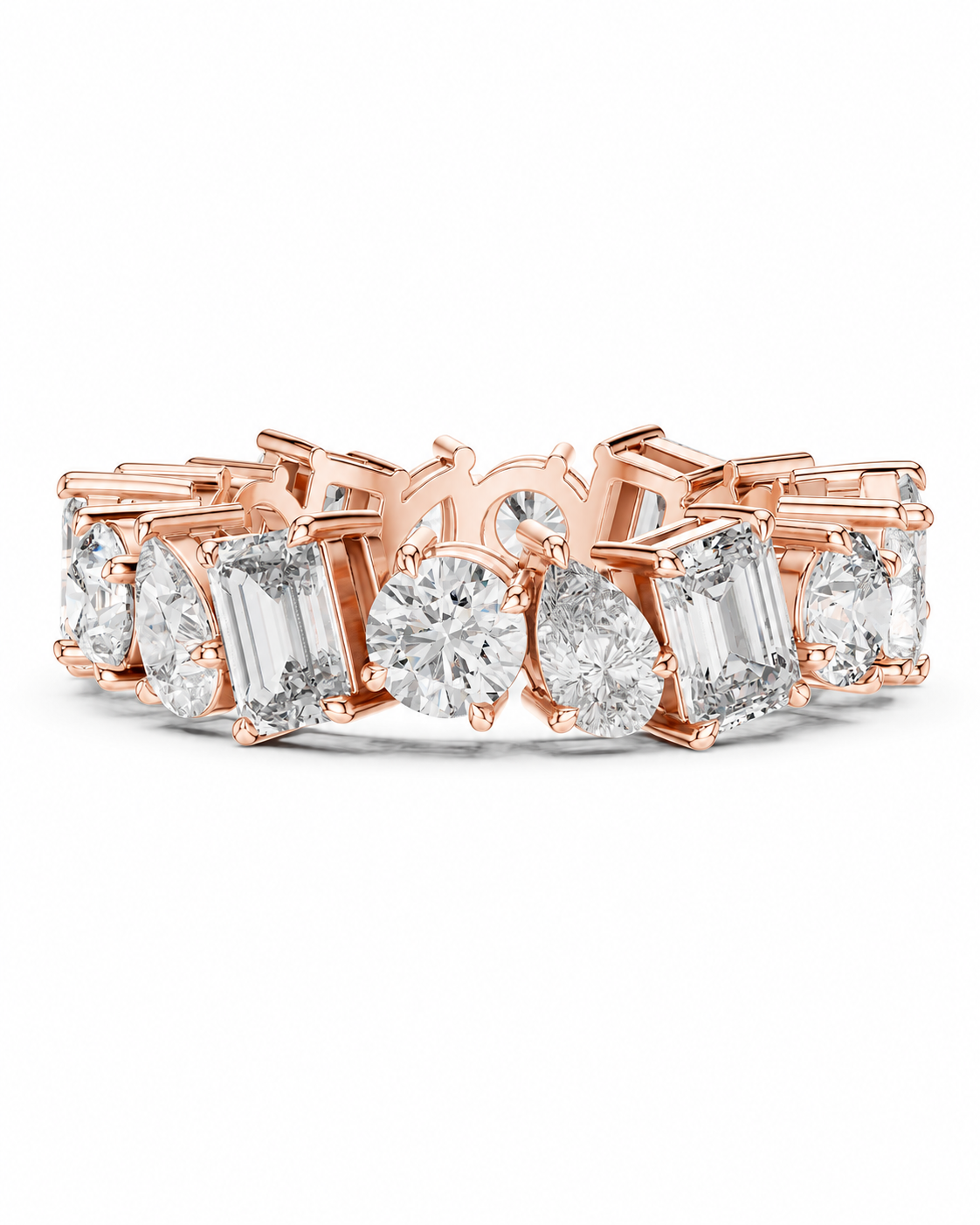 color_10K_RG, color_14K_RG &&	A rose gold eternity band ring featuring a continuous row of clear gemstones in various shapes including round, oval, and baguette cuts, set against a plain white background.