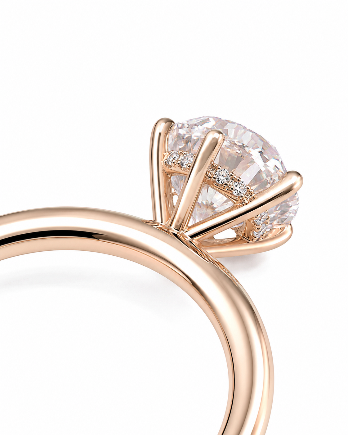 color_10K_RG, color_14K_RG &&Close-up of a rose gold engagement ring featuring a round brilliant-cut diamond center stone and small accent diamonds on the band, set against a clean white background.