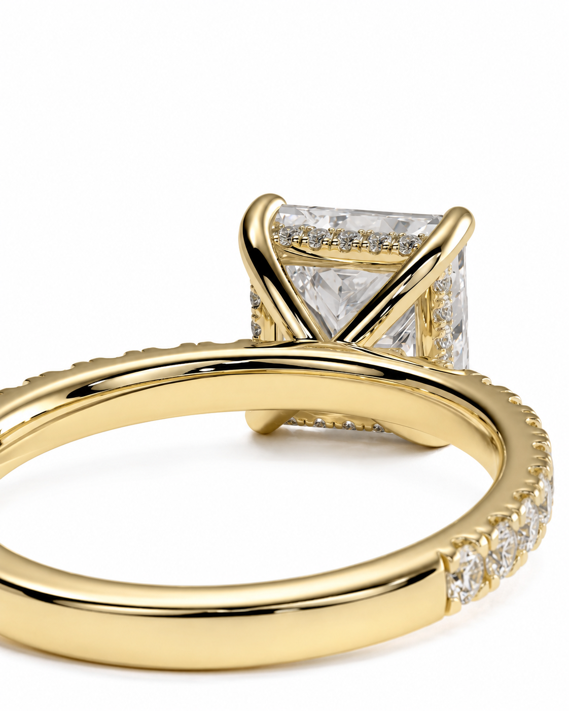 color_10K_YG, color_14K_YG &&A close-up shot of a yellow gold ring featuring a square-cut clear gemstone in a prong setting with small accent stones along the band, set against a plain white background.