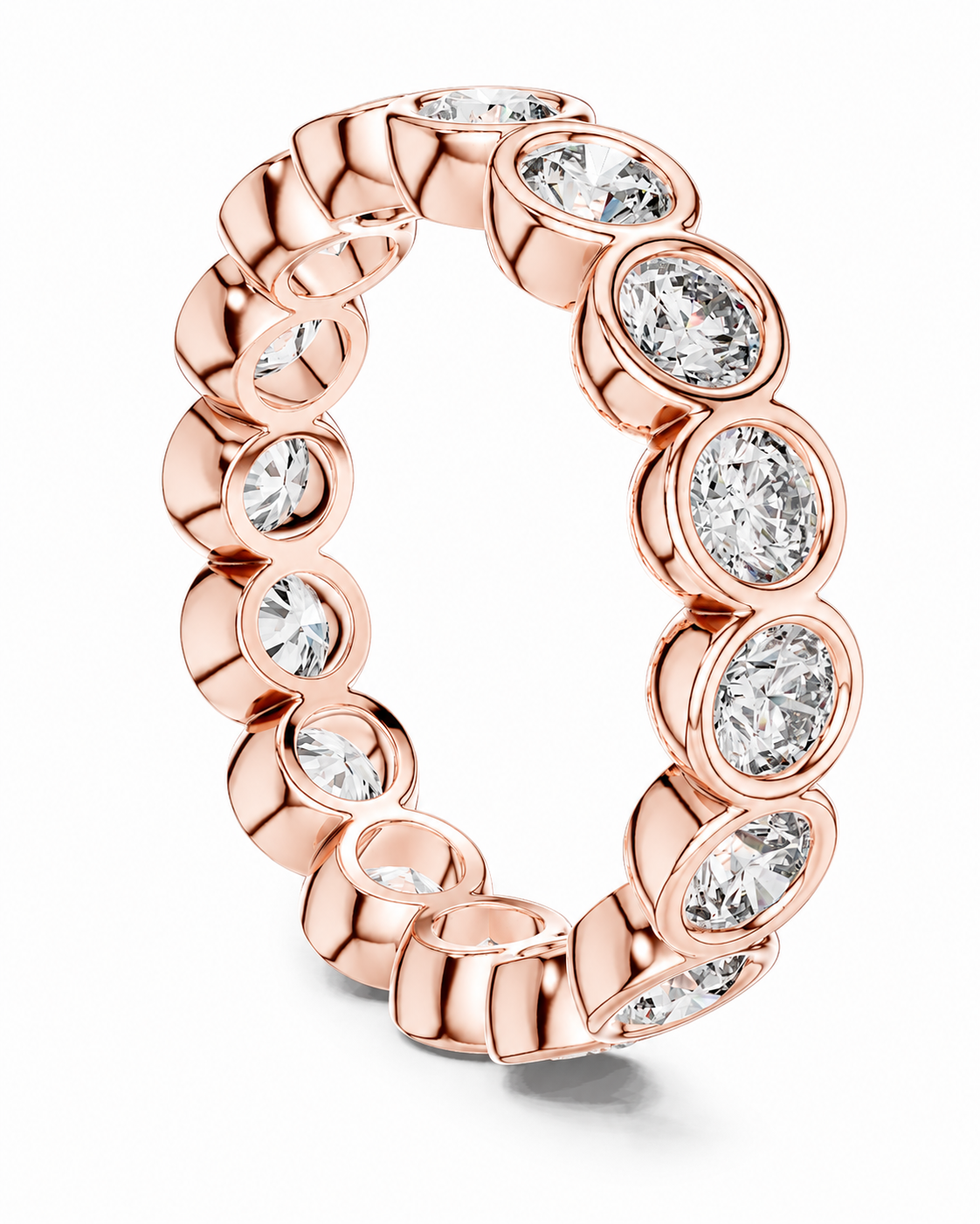color_10K_RG, color_14K_RG &&	A rose gold eternity ring featuring a continuous row of bezel-set oval clear gemstones, shown on a clean white background.