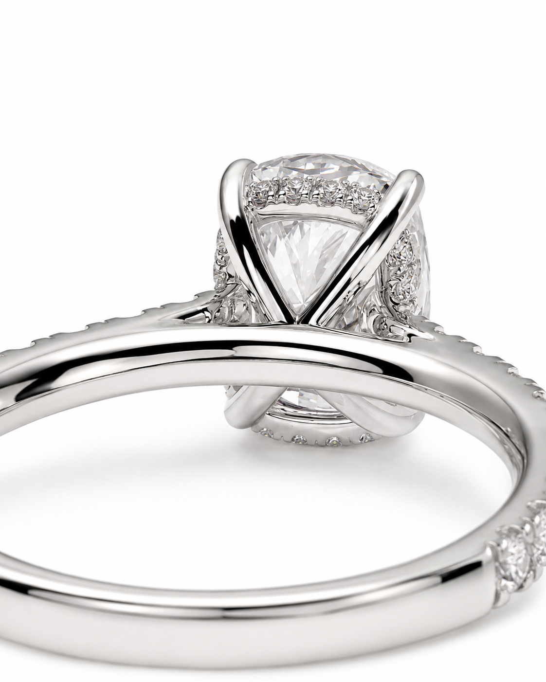 color_925_SIL,color_935_ARG,color_10K_WG, color_14K_WG &&A close-up studio shot of a silver-toned diamond ring featuring a triangular center stone surrounded by halo and pave diamonds, with an intertwined band design.