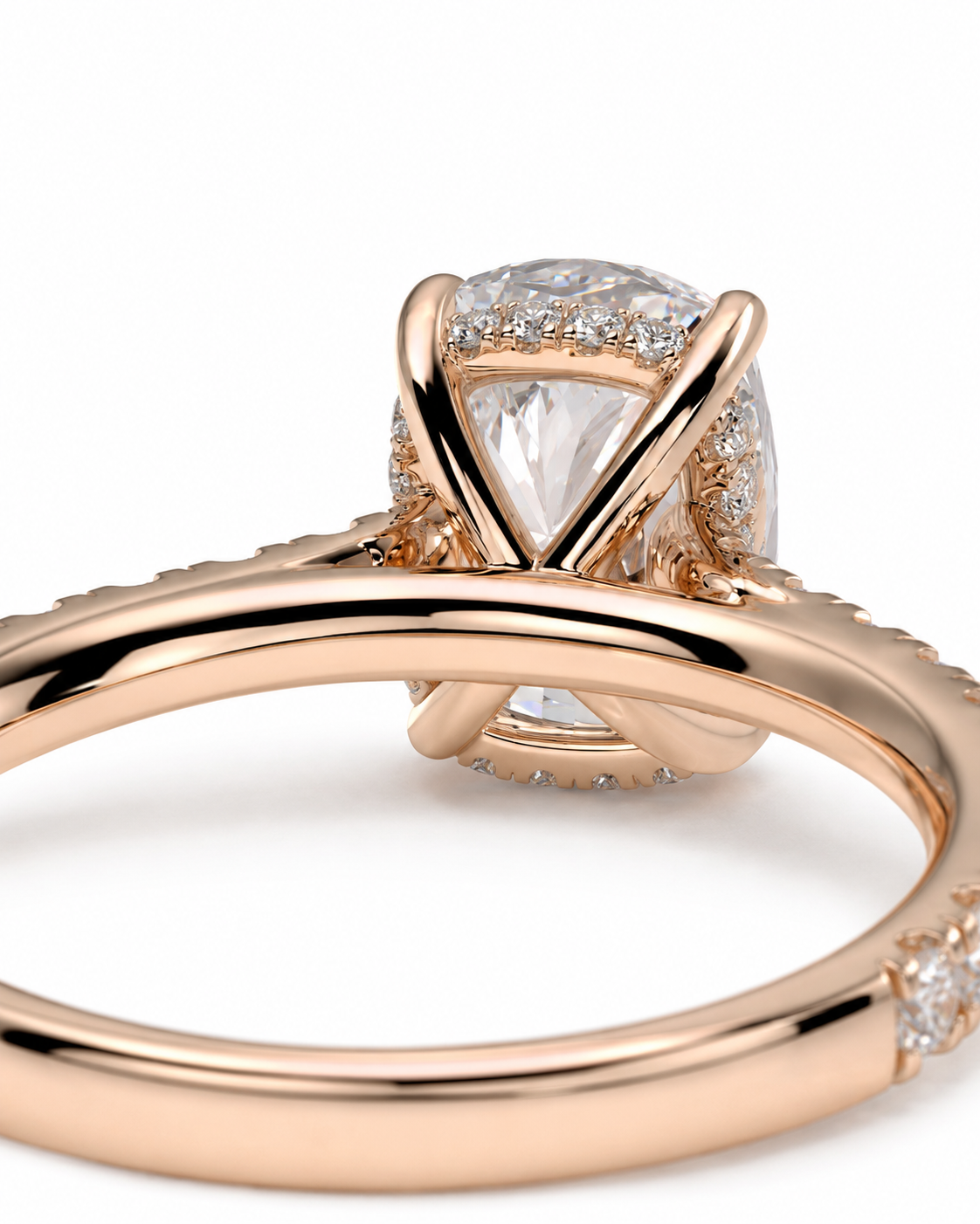 color_10K_RG, color_14K_RG &&Rose gold ring with a pear-cut clear center stone and small accent stones, shown in a close-up studio shot on a white background.
