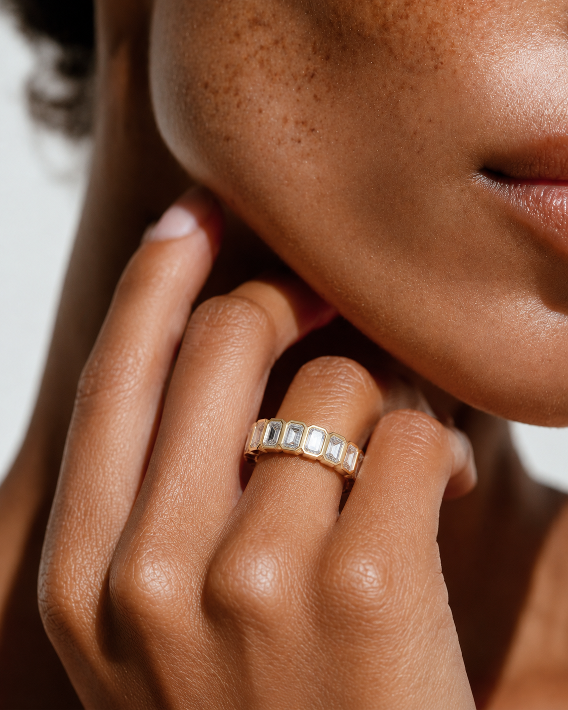color_10K_YG, color_14K_YG &&	
Premium emerald cut moissanite wedding band with sleek geometric bezel design.