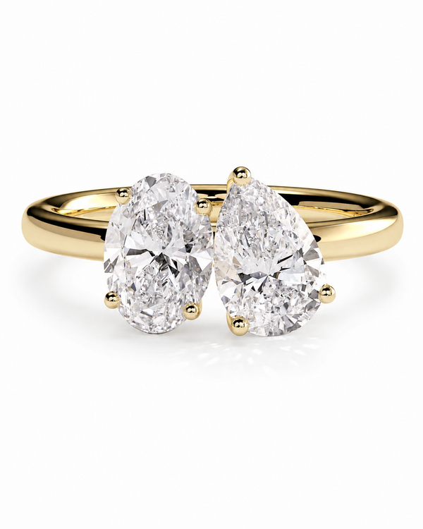 color_10K_YG, color_14K_YG &&A yellow gold double-ring engagement ring featuring two pear-cut diamonds in a prong setting, shown on a clean white background.
