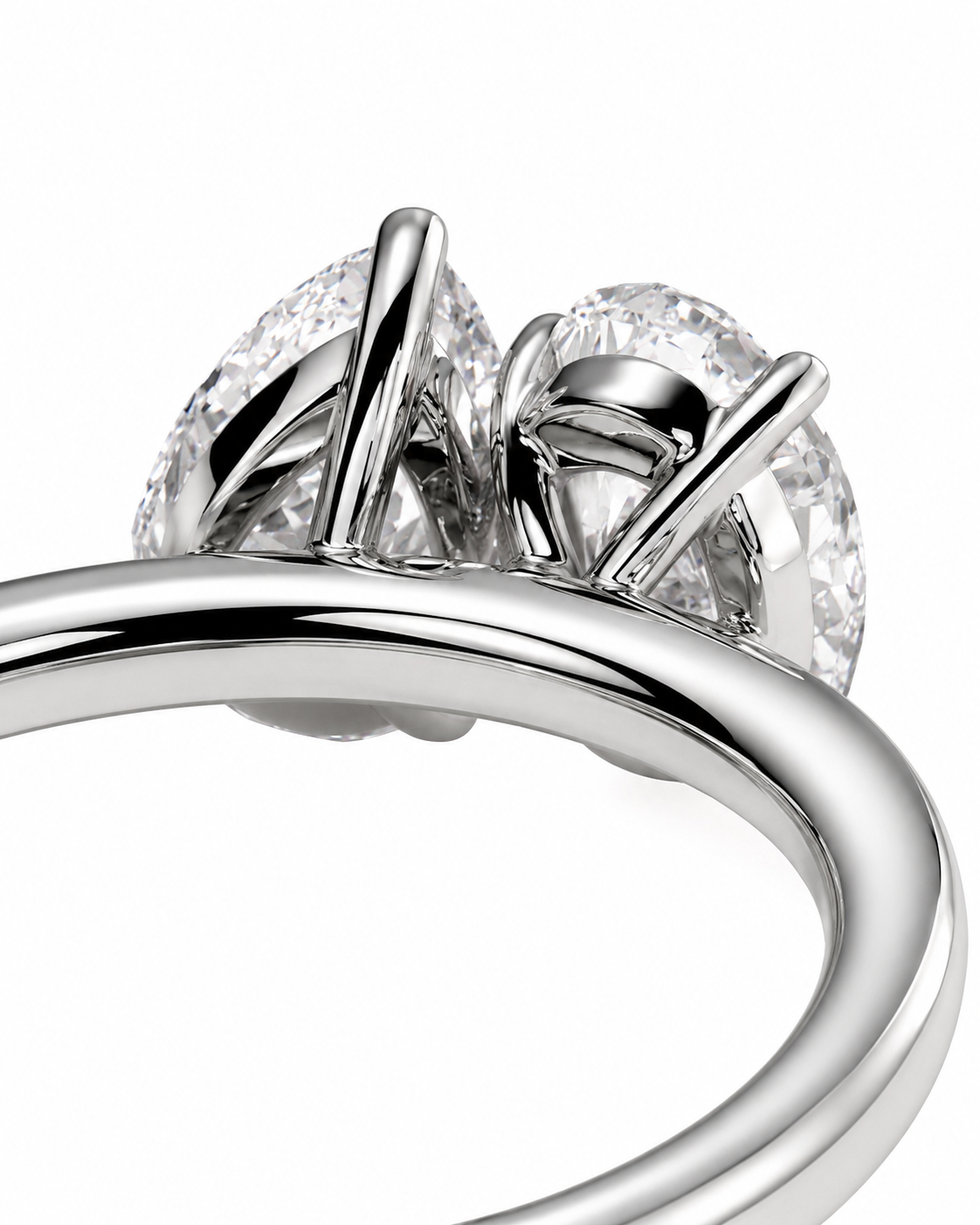color_925_SIL,color_935_ARG,color_10K_WG, color_14K_WG &&Close-up of a silver-toned ring with two marquise-cut clear gemstones in a prong setting, shown on a white background.