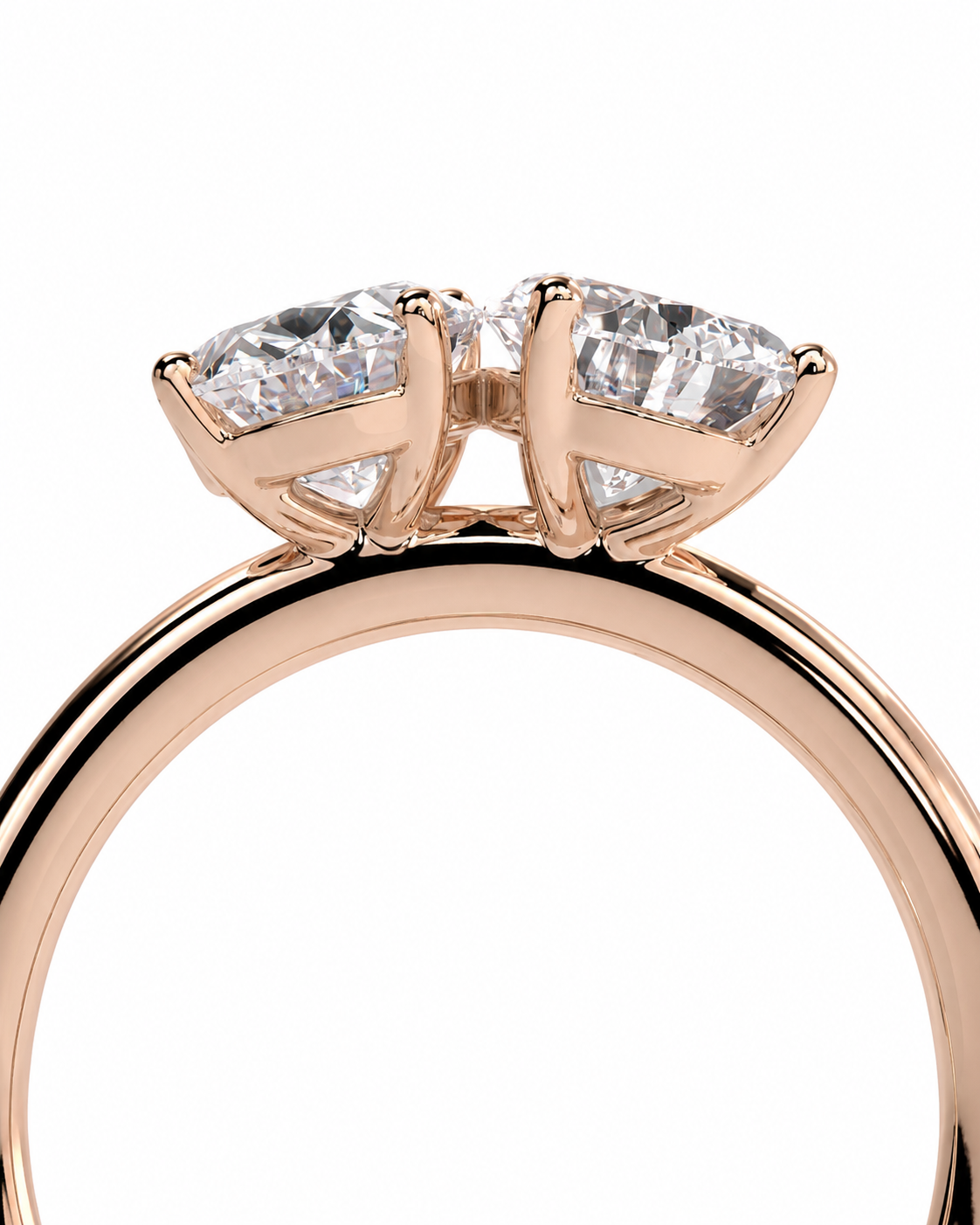 color_10K_RG, color_14K_RG &&A close-up of a rose gold ring featuring a double-prong setting with two clear oval-cut gemstones, shown against a plain white background.