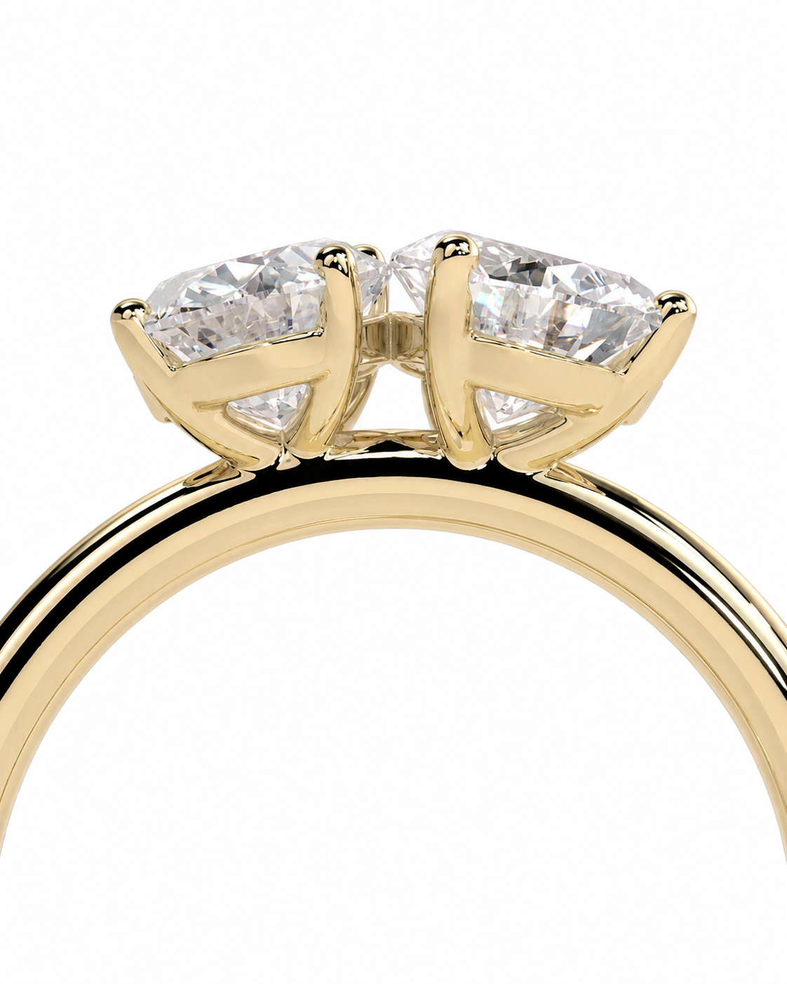 color_10K_YG, color_14K_YG &&A close-up of a yellow gold ring featuring two round brilliant-cut clear gemstones in a four-prong setting, shown against a plain white background.