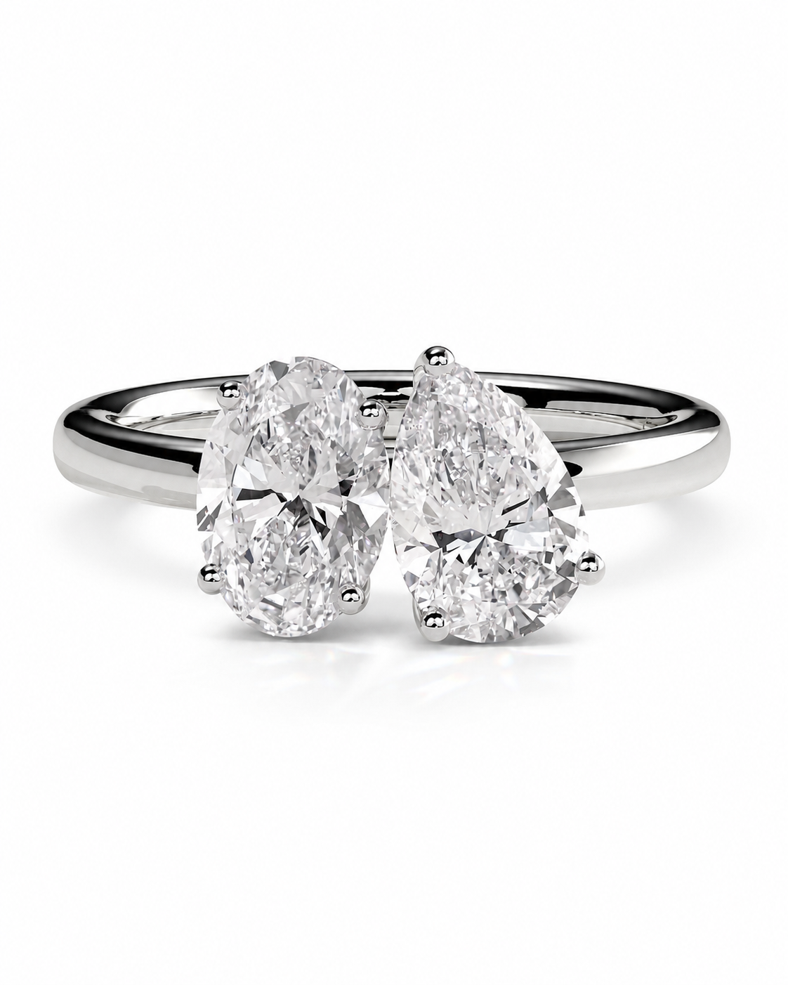 color_925_SIL,color_935_ARG,color_10K_WG, color_14K_WG &&A silver engagement ring featuring two pear-cut diamonds in a four-prong setting on a polished band, shown against a plain white background.