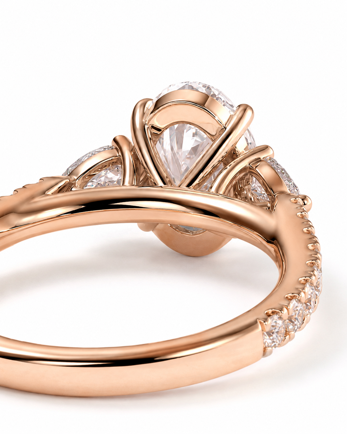 color_10K_RG, color_14K_RG &&Rose gold engagement ring with a large pear-cut center stone and small accent diamonds, shown in a close-up studio shot on a white background.