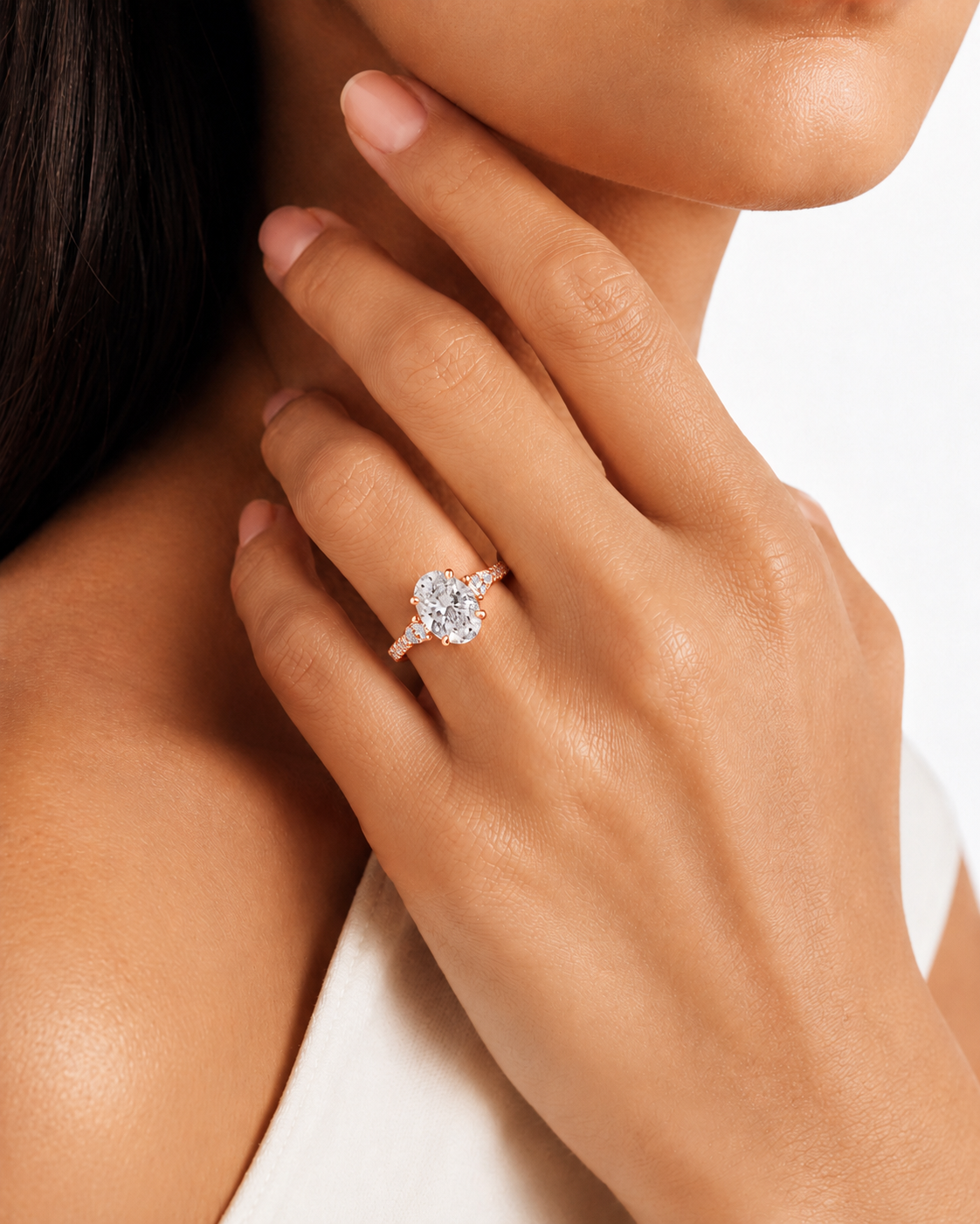 color_10K_RG, color_14K_RG &&A close-up lifestyle shot of a model wearing a rose gold ring with a heart-shaped clear gemstone on her finger, set against a clean white background.