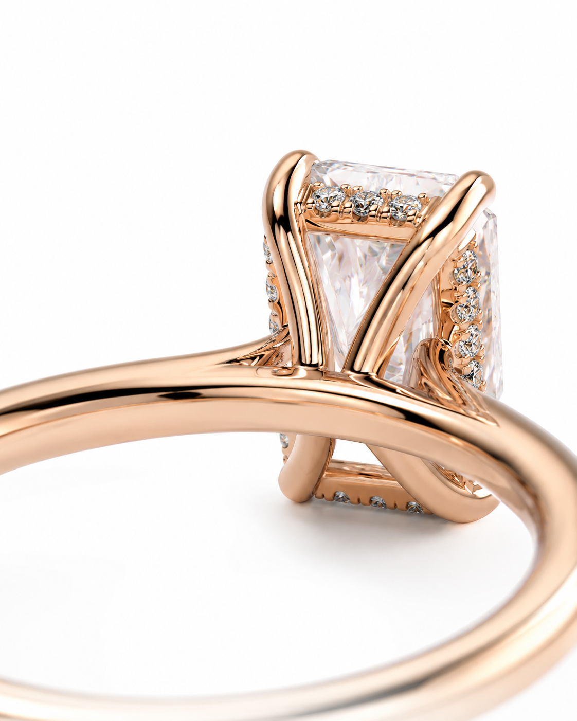 color_10K_RG, color_14K_RG &&Rose gold ring with a large rectangular clear gemstone and small accent stones, shown in a close-up studio shot on a white background.