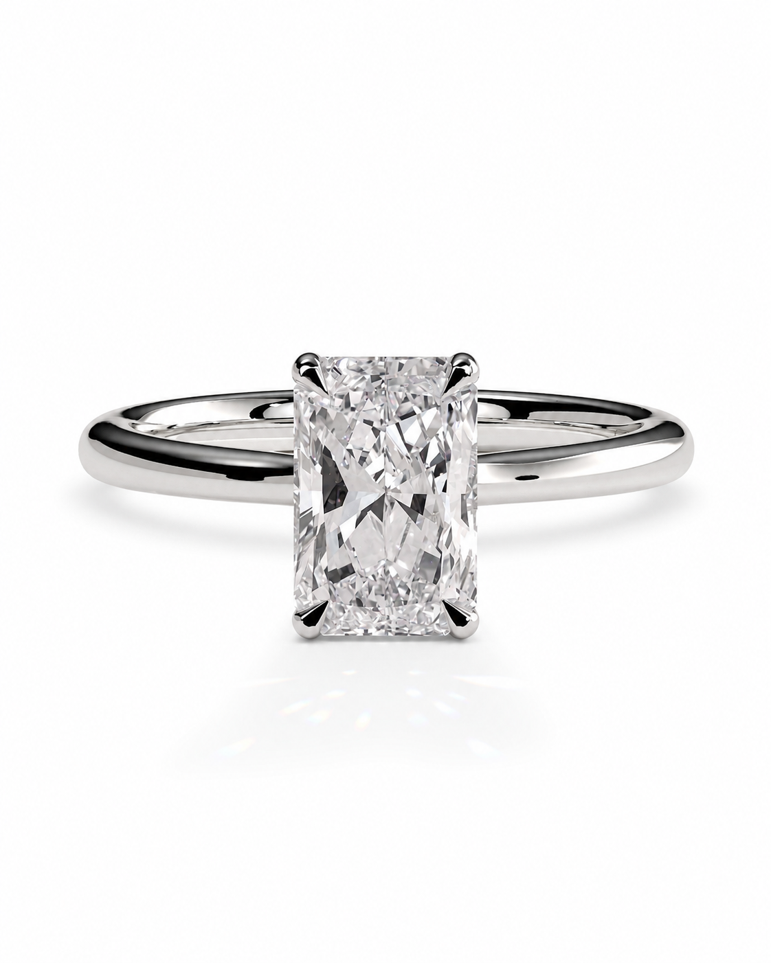 color_925_SIL,color_935_ARG,color_10K_WG, color_14K_WG &&An radiant cut diamond engagement ring in a polished silver-colored metal band, centered on a clean white background with a soft reflection below.