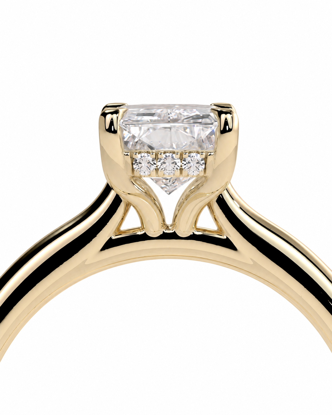 color_10K_YG, color_14K_YG &&A close-up of a yellow gold ring with a rectangular clear center stone and small side stones in a prong setting, shown on a plain white background.